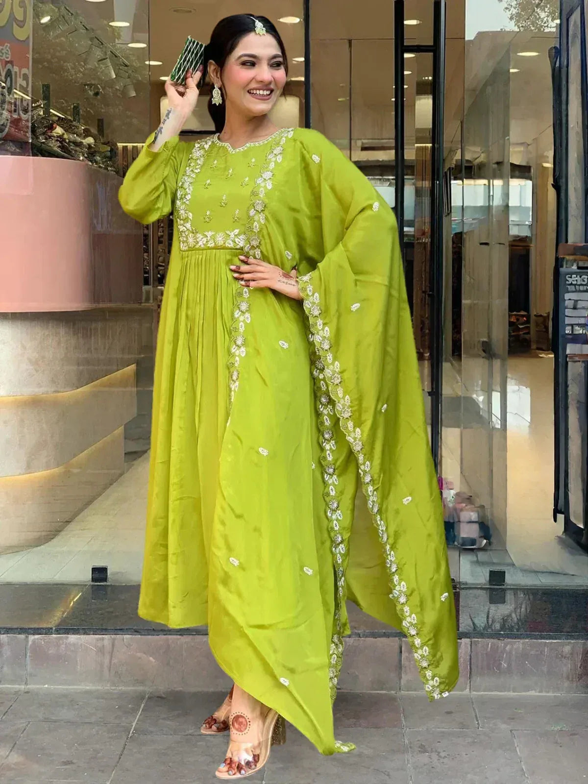 Lime green embroidered ethnic gown with flared sleeves, perfect for Indian festive occasions and weddings.