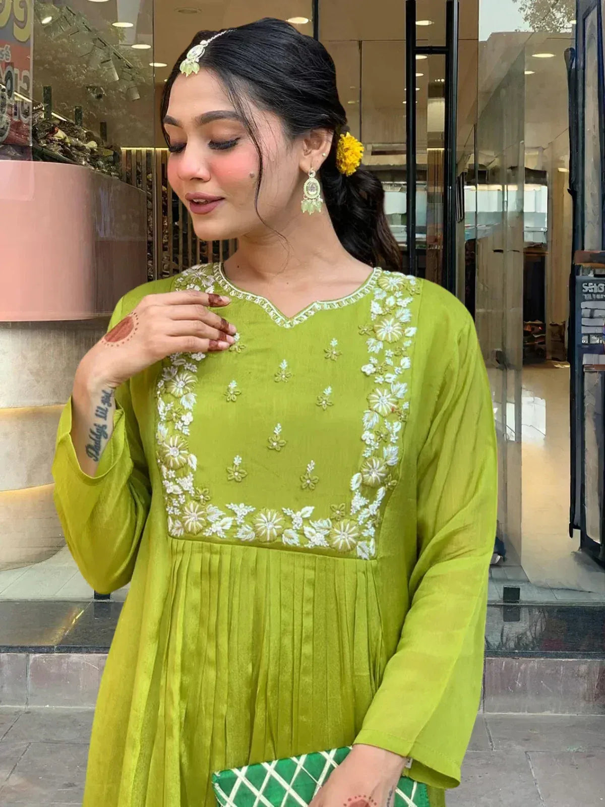 Woman in green embroidered kurta with floral detailing, styled for Indian ethnic wear