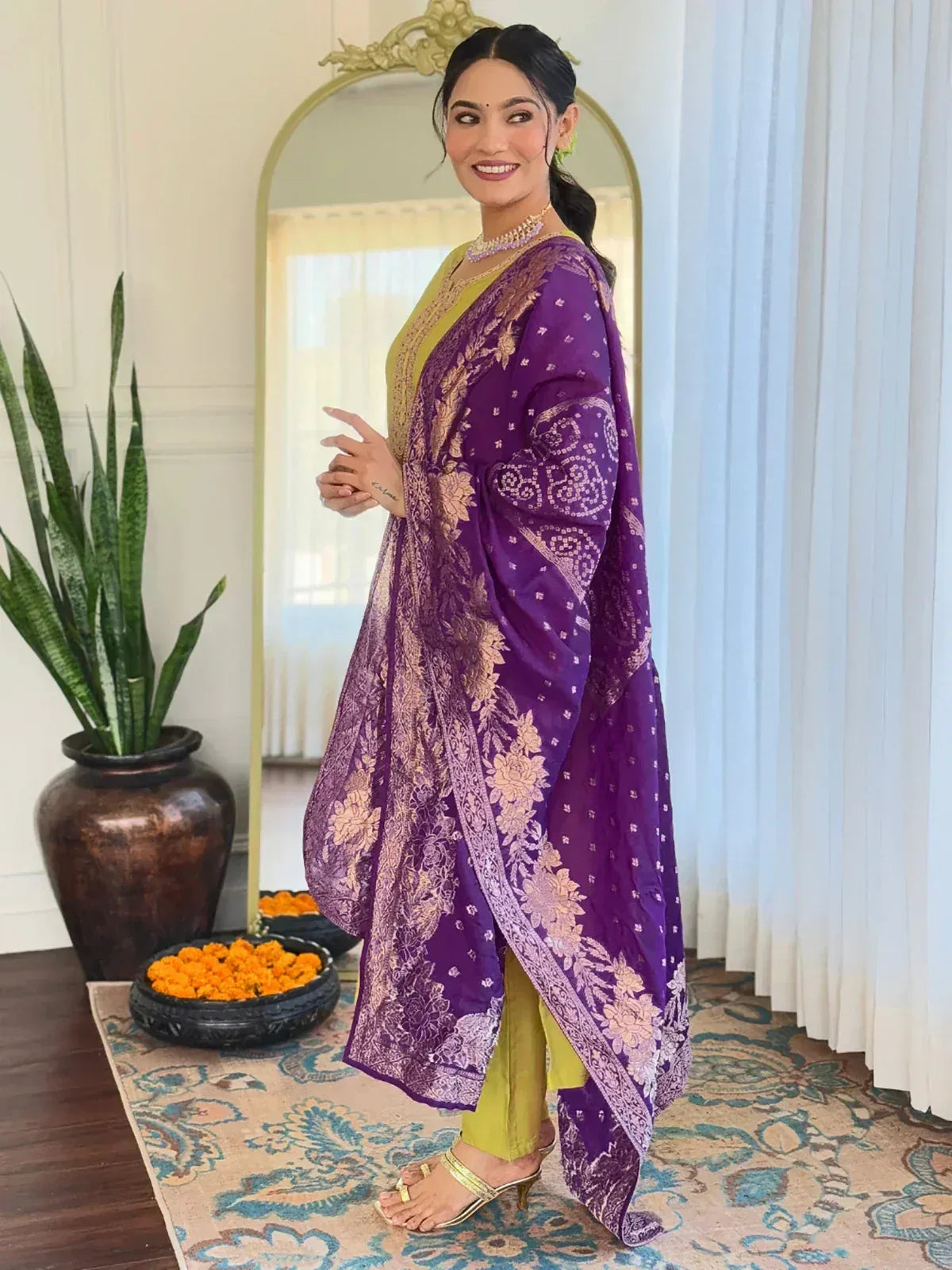Woman in purple floral printed ethnic gown with yellow inner, perfect for Indian occasions and festivals