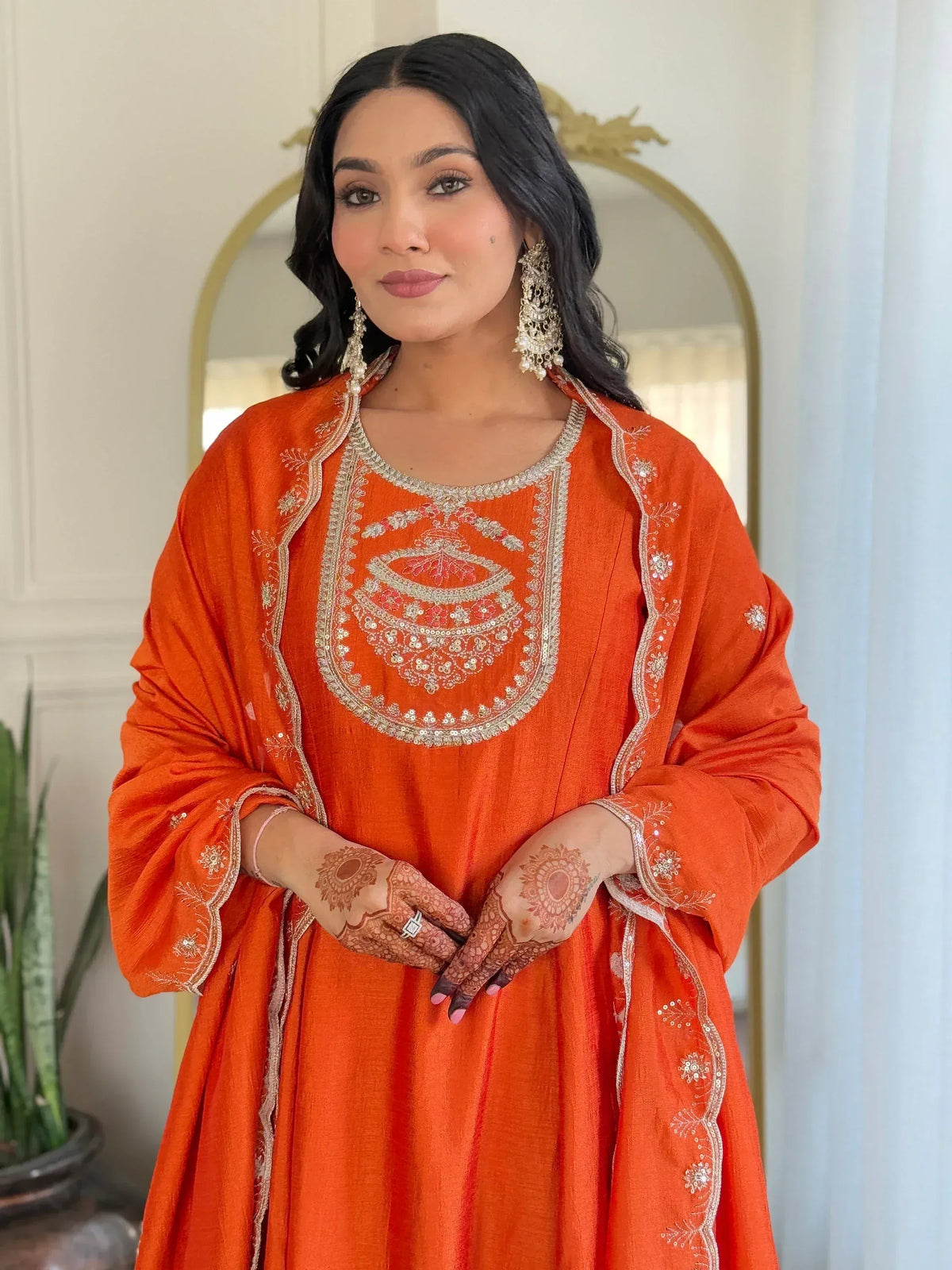 Orange embroidered ethnic kurta with gold detailing, perfect for Indian celebrations and festive occasions.