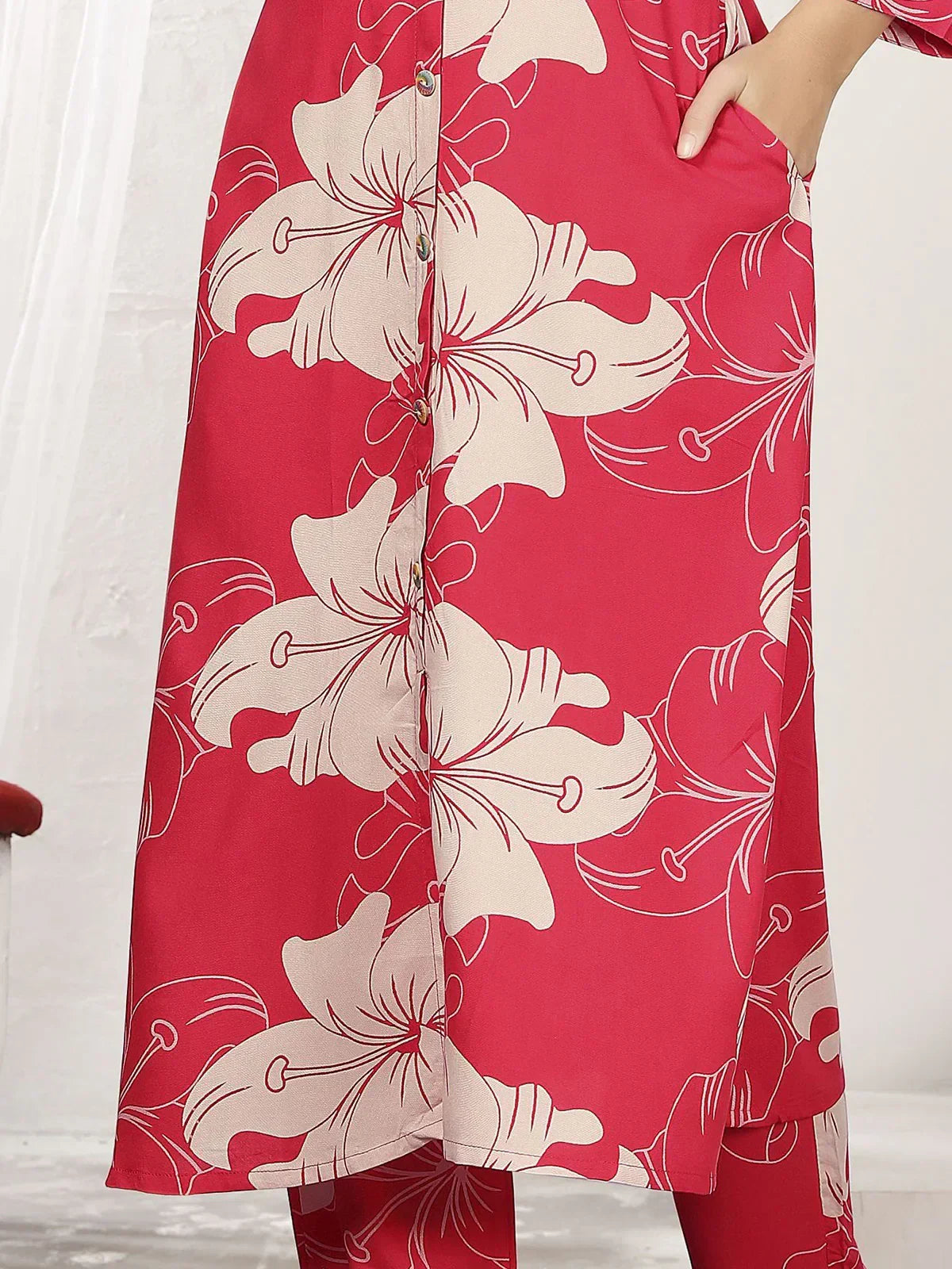Red kurti with beige floral print and front buttons, featuring a side pocket