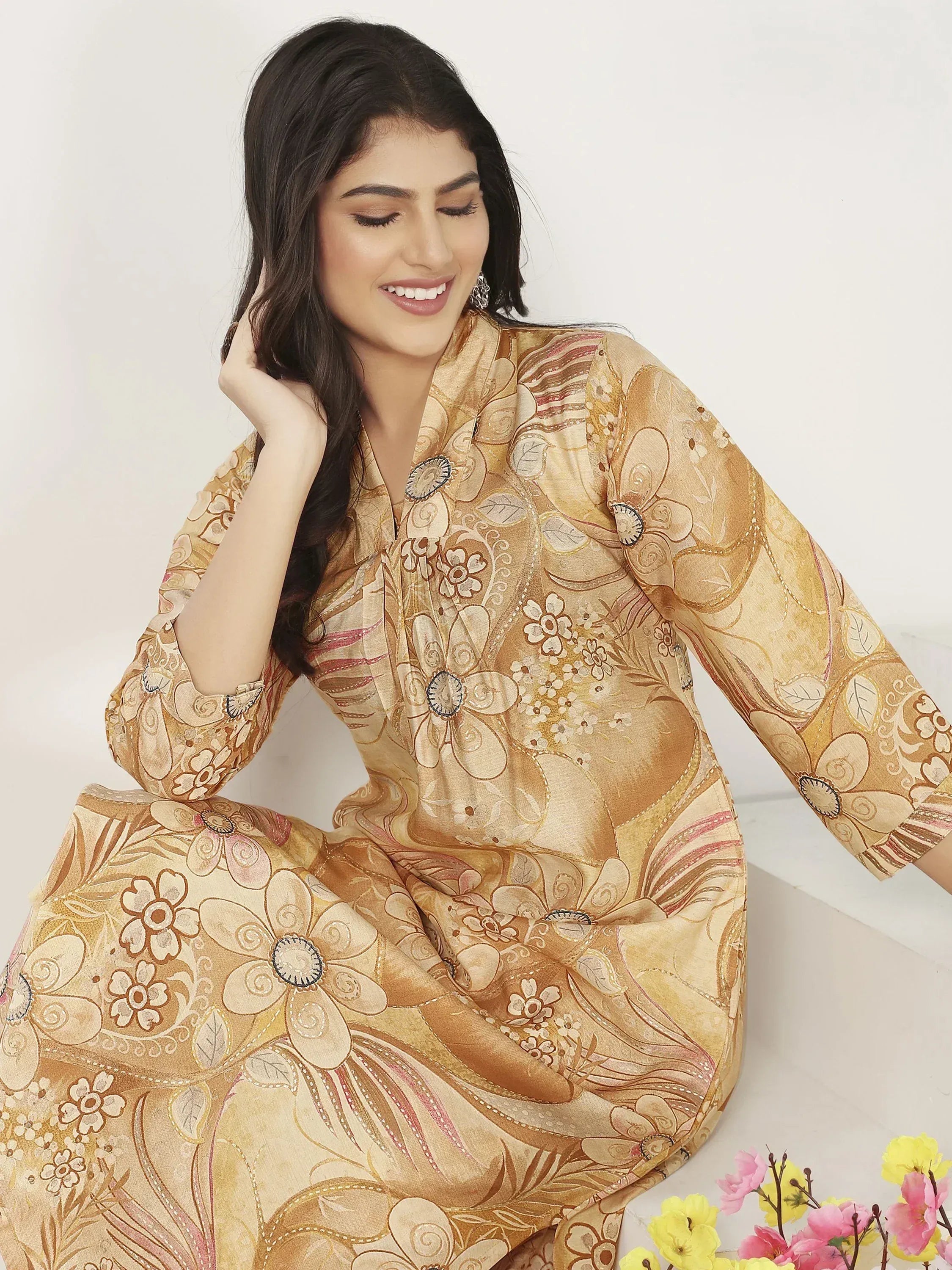 Woman in elegant floral print ethnic gown with gold tones, perfect for Indian occasions