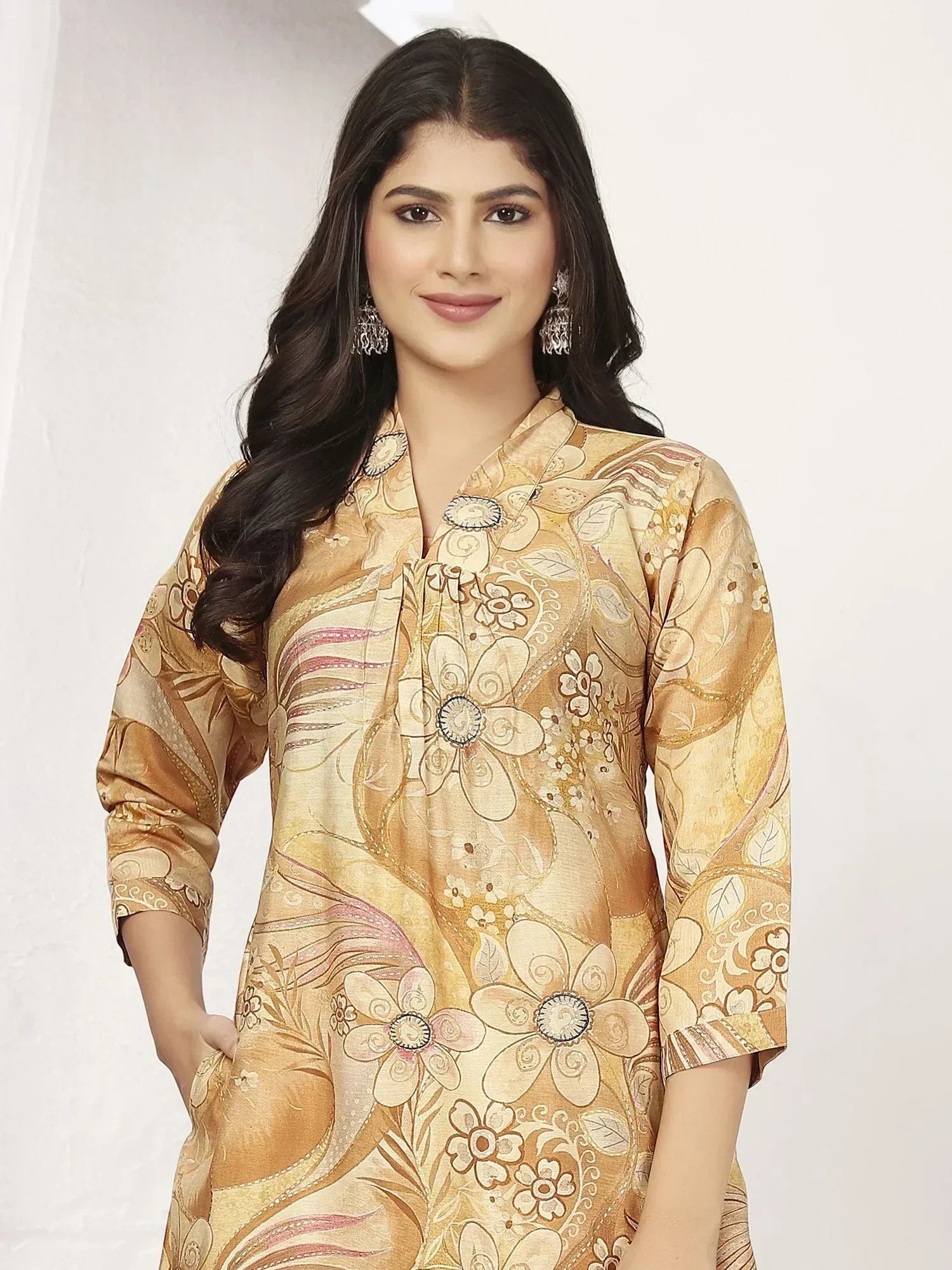 Woman in golden floral print ethnic kurta with 3/4 sleeves, perfect for Indian festive occasions