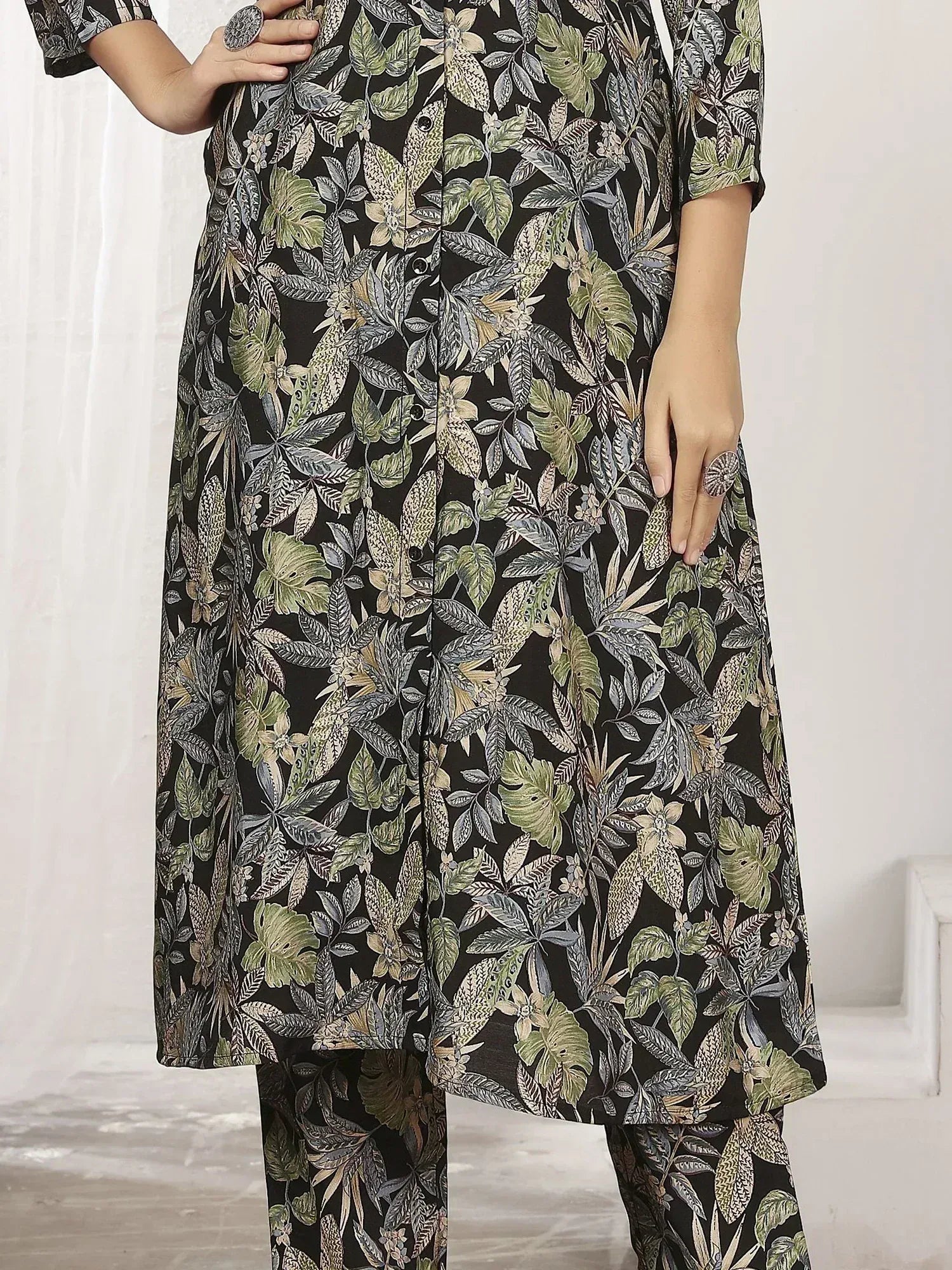 Black floral print salwar kameez with green leaf pattern, ethnic wear for women