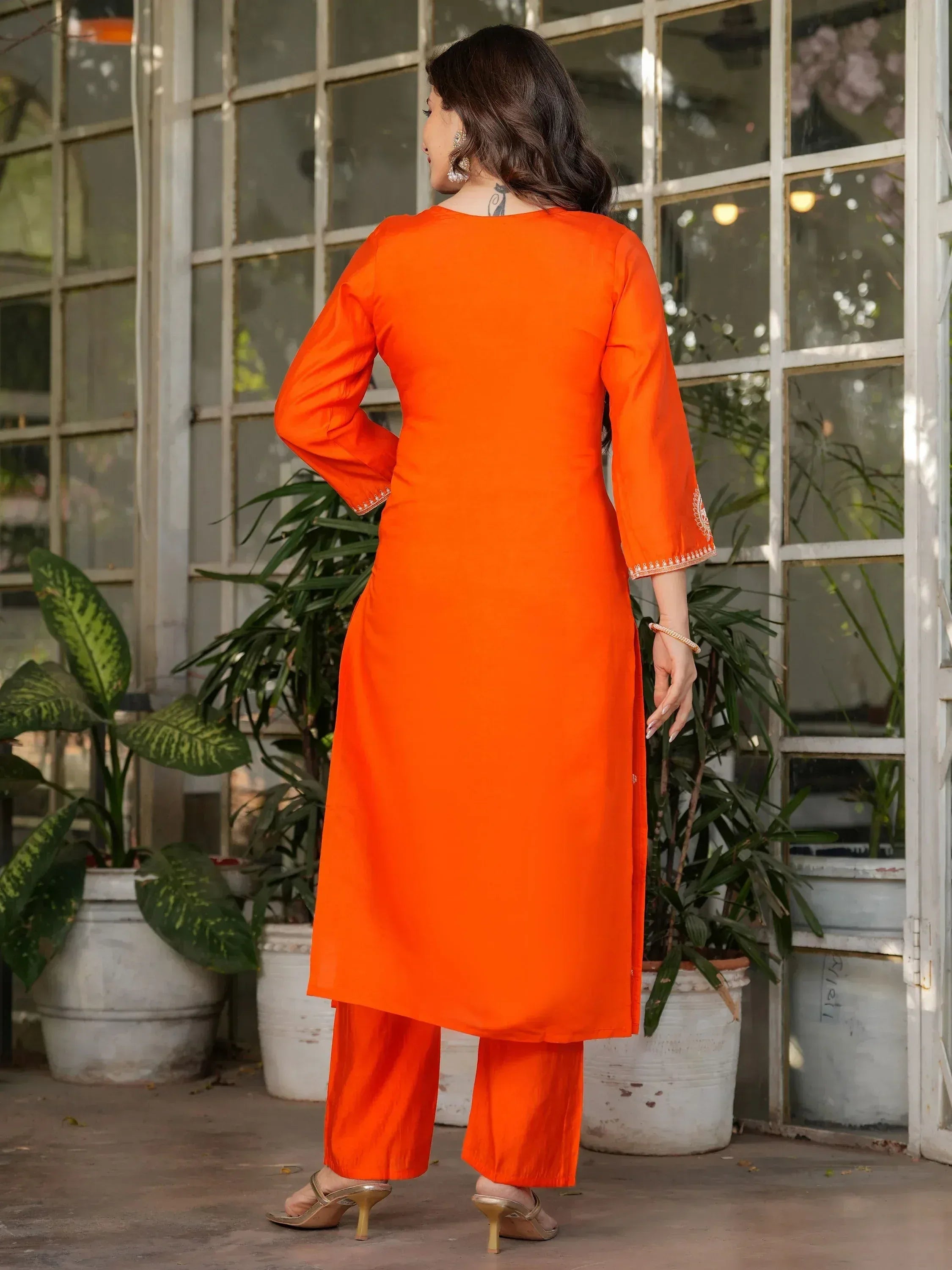 Vibrant orange ethnic kurta with embroidered sleeves paired with matching palazzo pants, perfect for Indian wear.