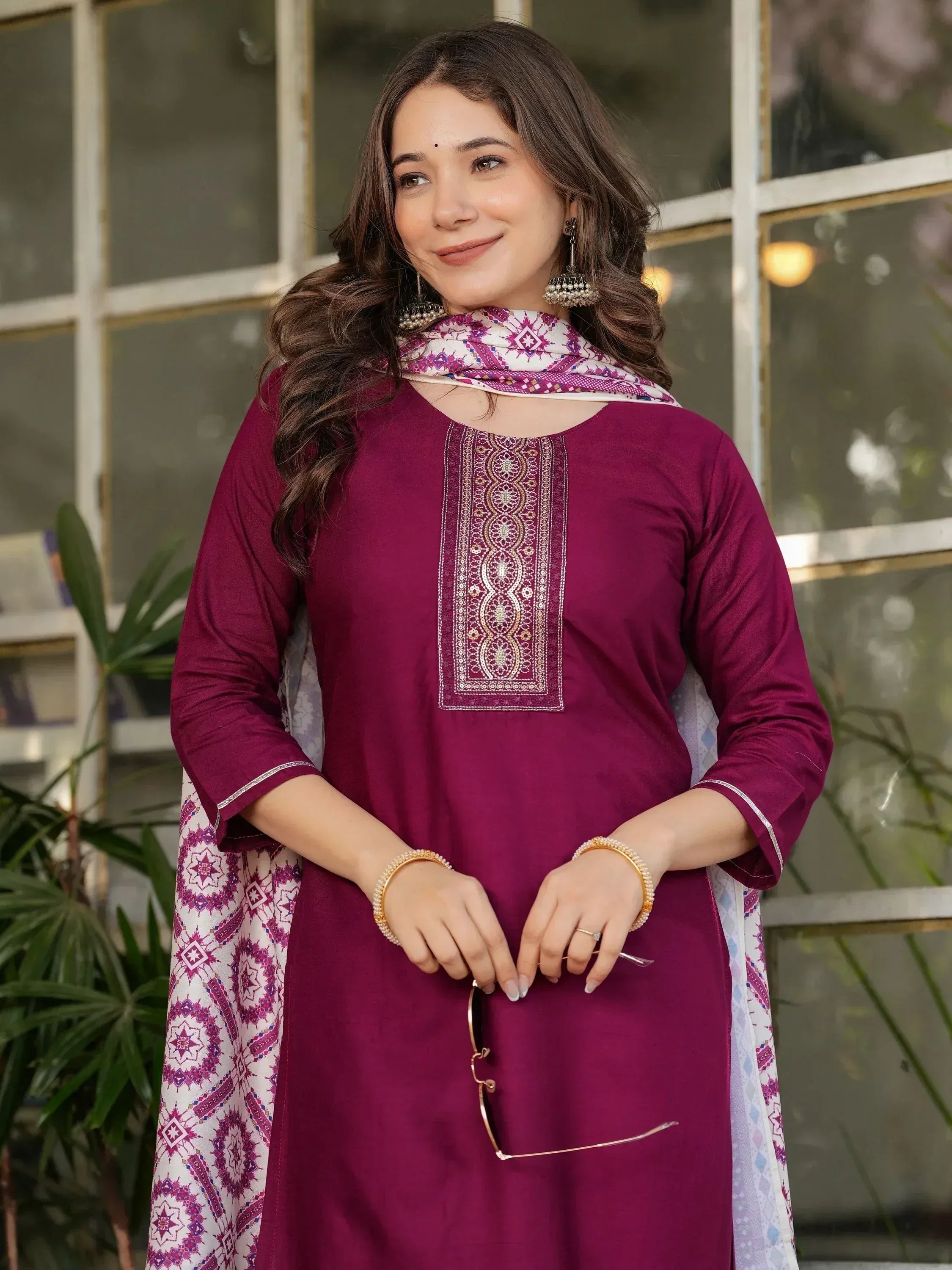Woman in maroon embroidered kurta with patterned dupatta, ethnic Indian wear