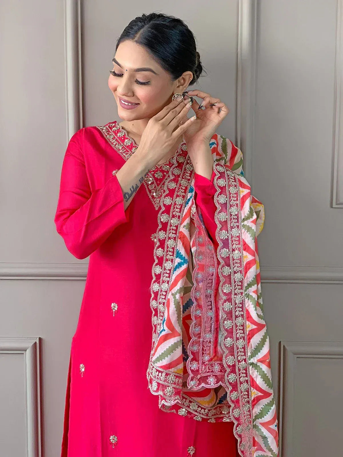 Woman in vibrant pink embroidered kurta with colorful dupatta, styling ethnic Indian wear