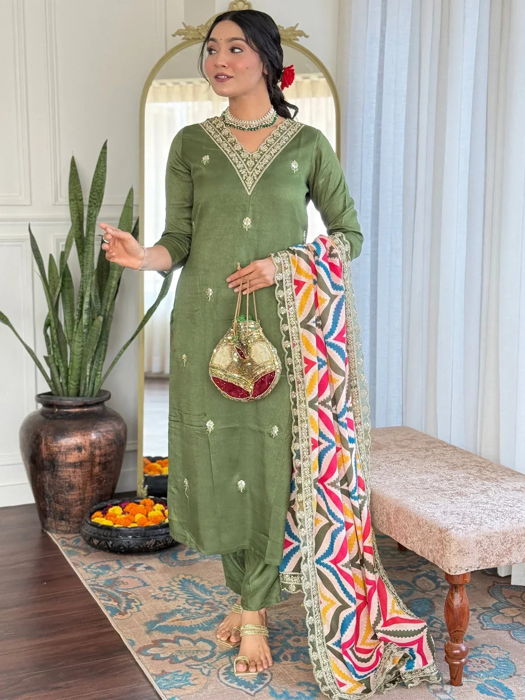 Green embroidered salwar kameez with colorful dupatta, perfect for Indian ethnic wear occasions.