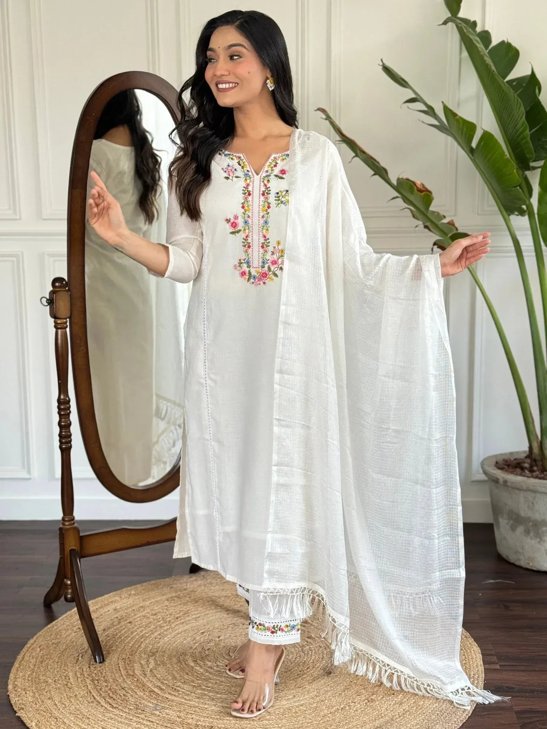 White embroidered kurta with floral details, paired with matching palazzo and dupatta, ideal for ethnic wear