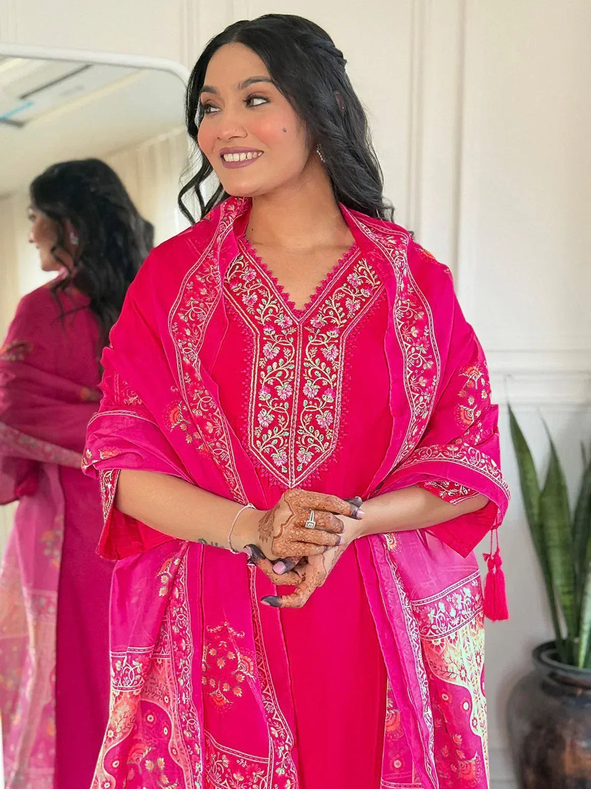 Woman in vibrant pink embroidered ethnic kurta with matching dupatta, perfect for Indian occasions