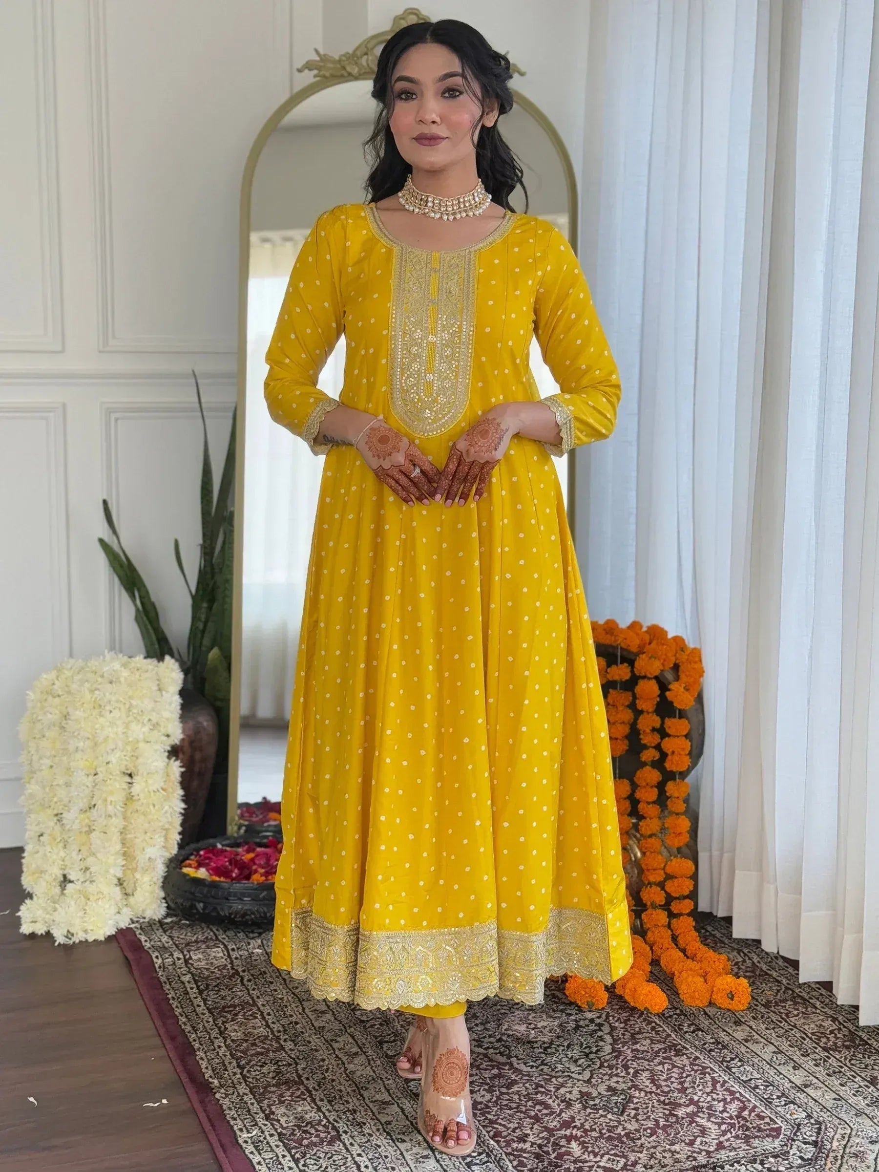 Yellow embroidered ethnic gown with gold detailing, perfect for Indian celebrations and festive occasions.