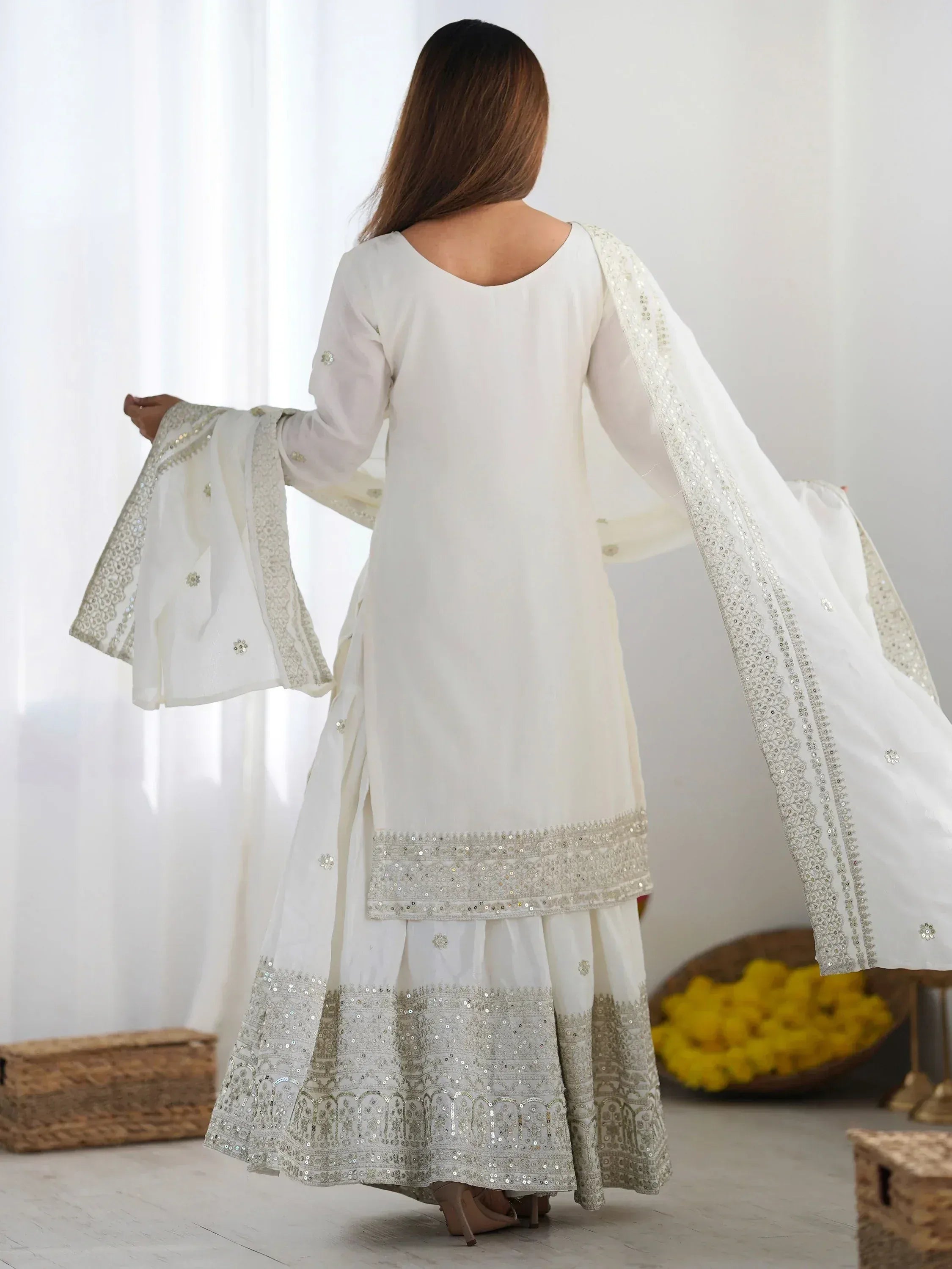 White embroidered salwar kameez with flared sleeves and sequin detailing, ideal for Indian ethnic wear