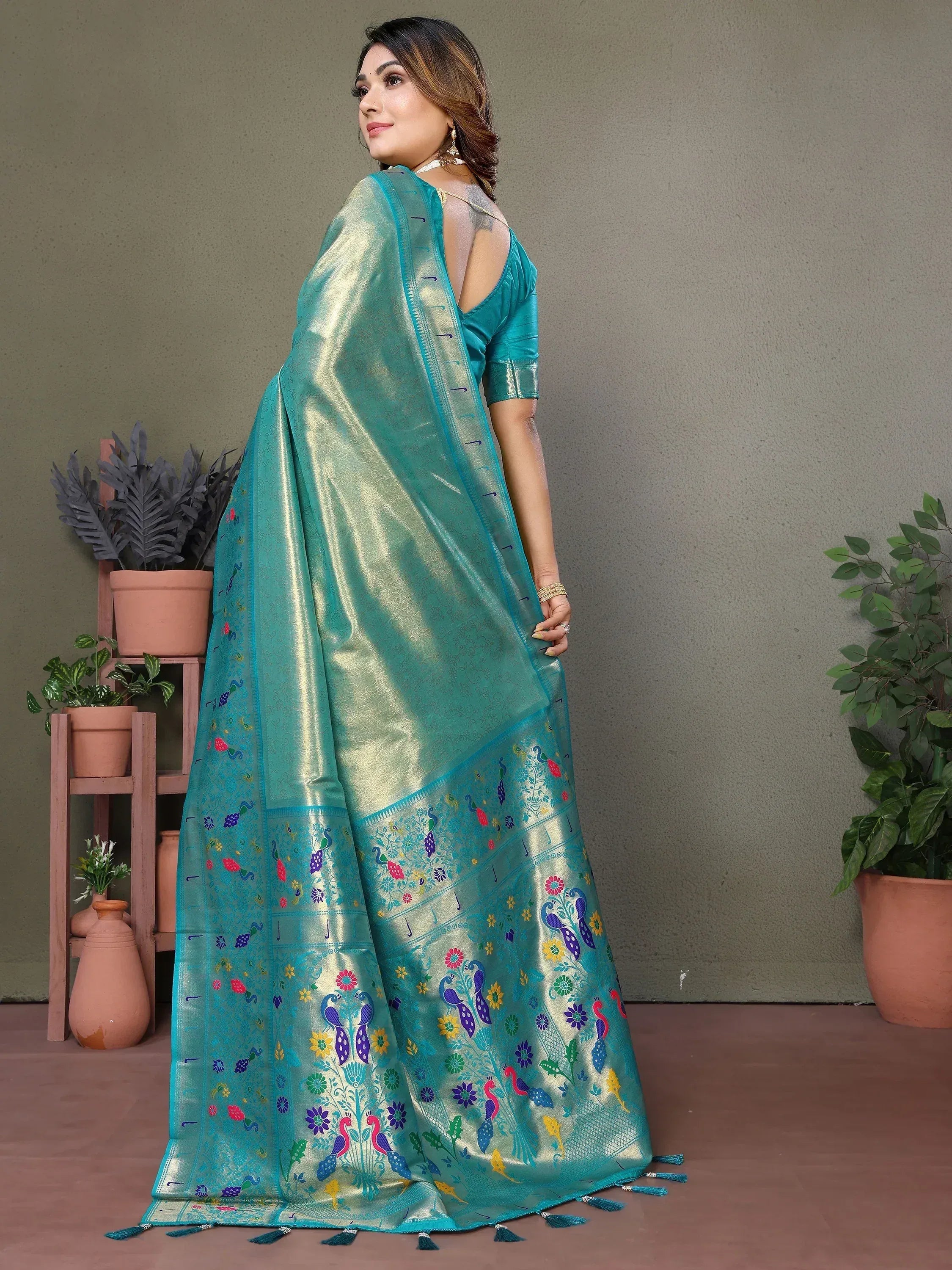 Teal saree with peacock and floral embroidery, perfect for ethnic occasions