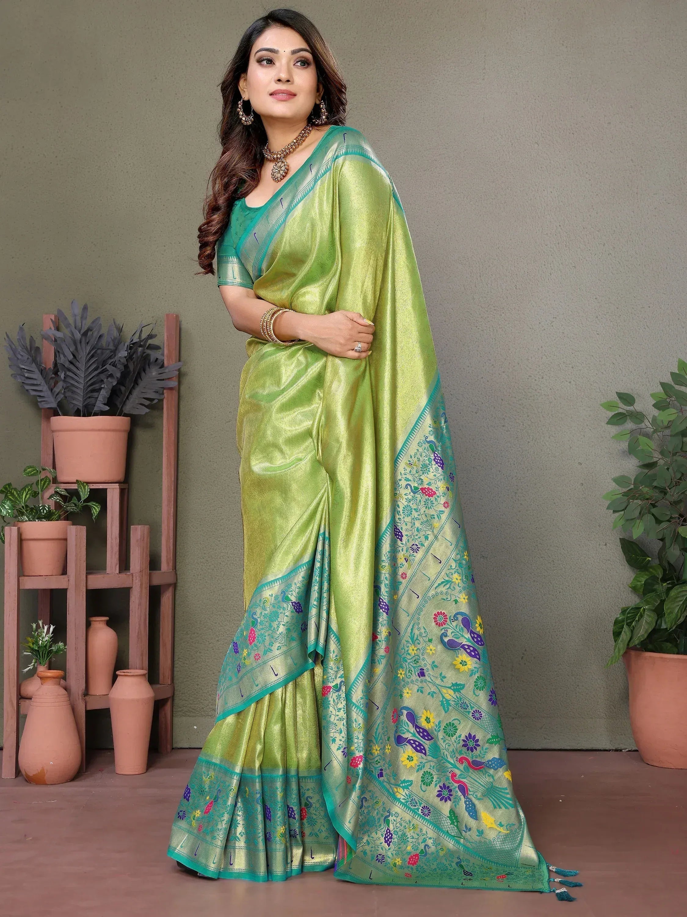 Green silk saree with peacock and floral embroidery, perfect for ethnic occasions