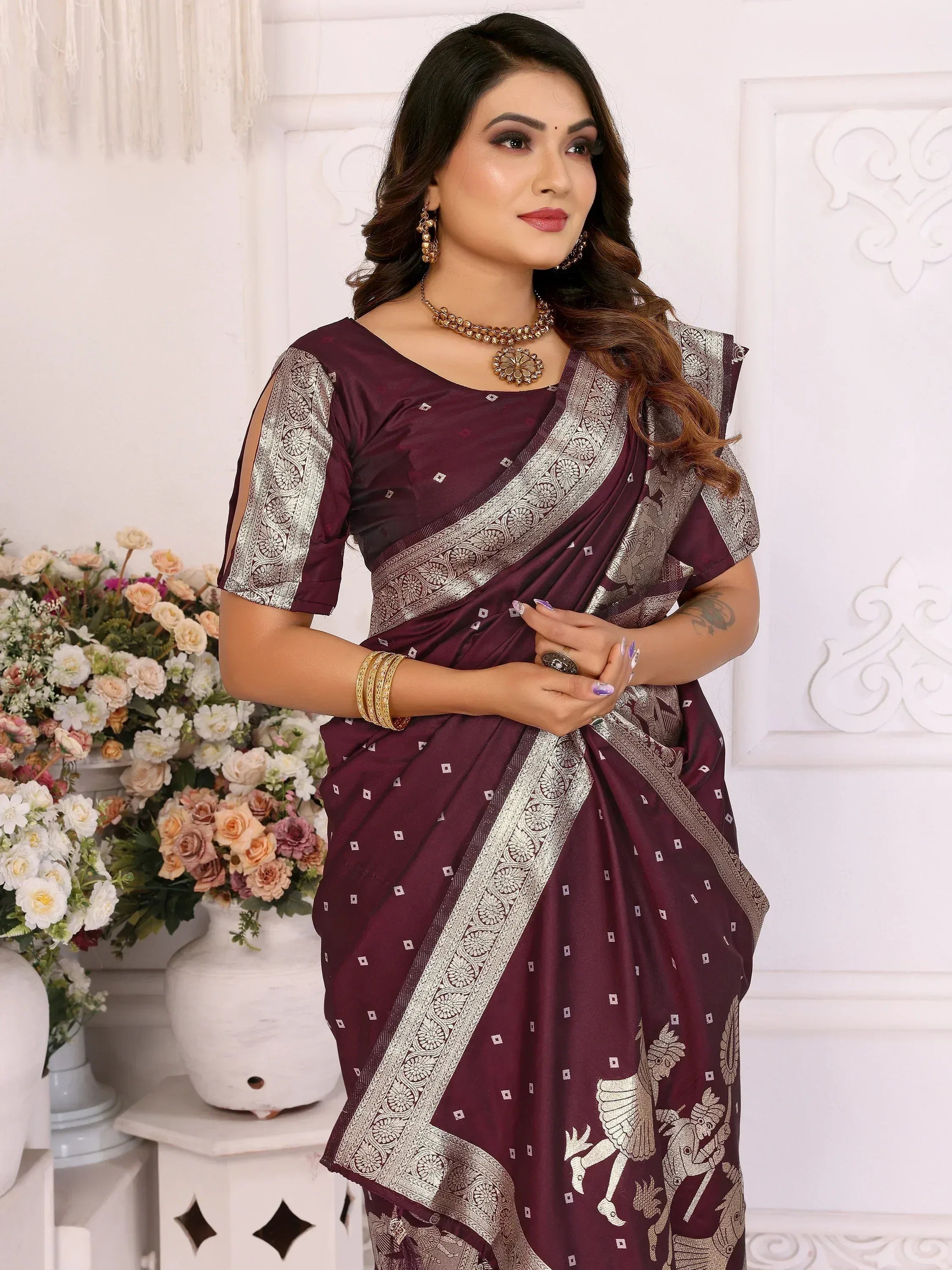 Elegant maroon saree with silver embroidery and traditional Indian motifs, perfect for festive occasions.