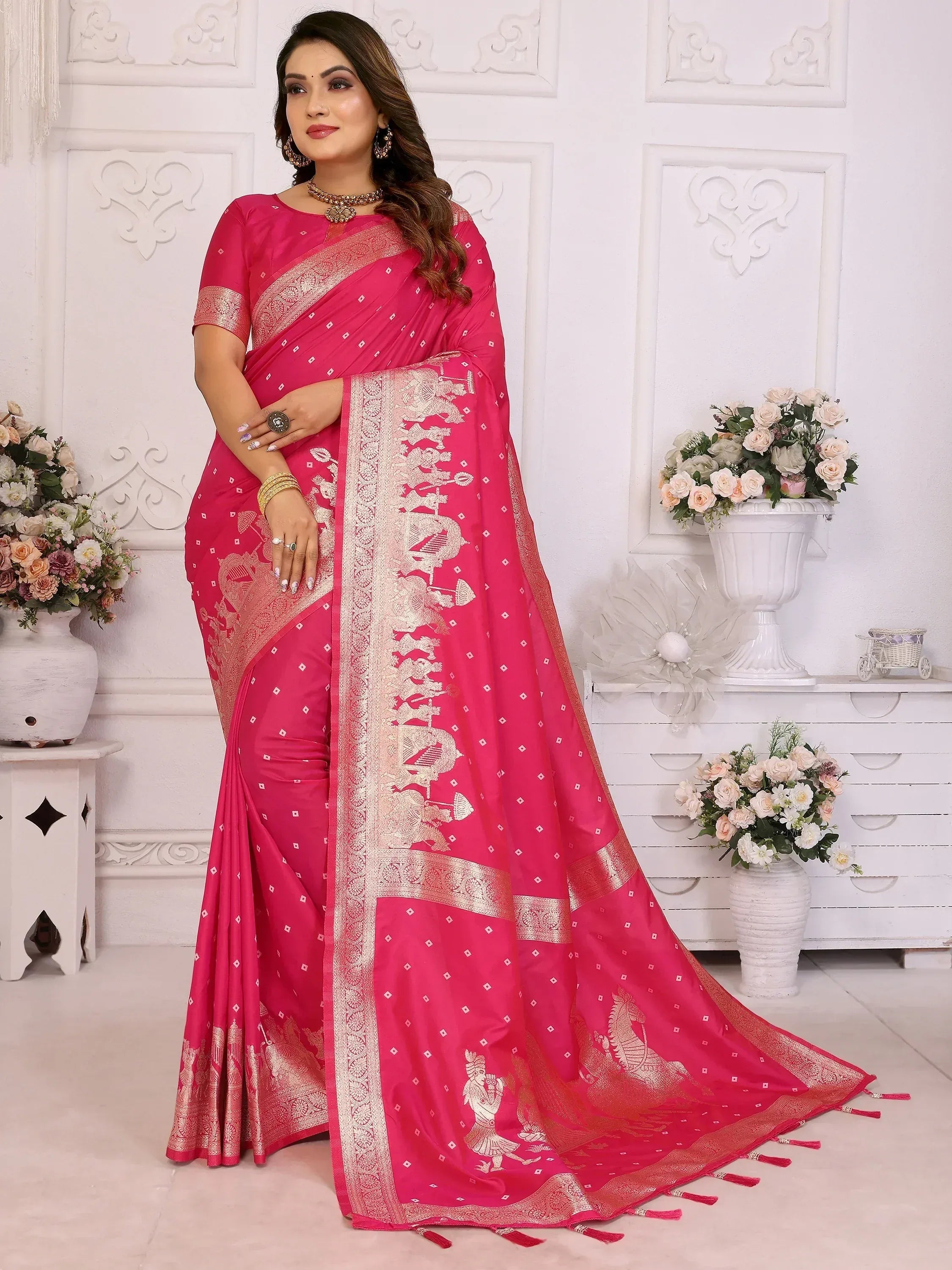 Pink designer saree with gold embroidery and tassels, perfect for Indian ethnic wear occasions.