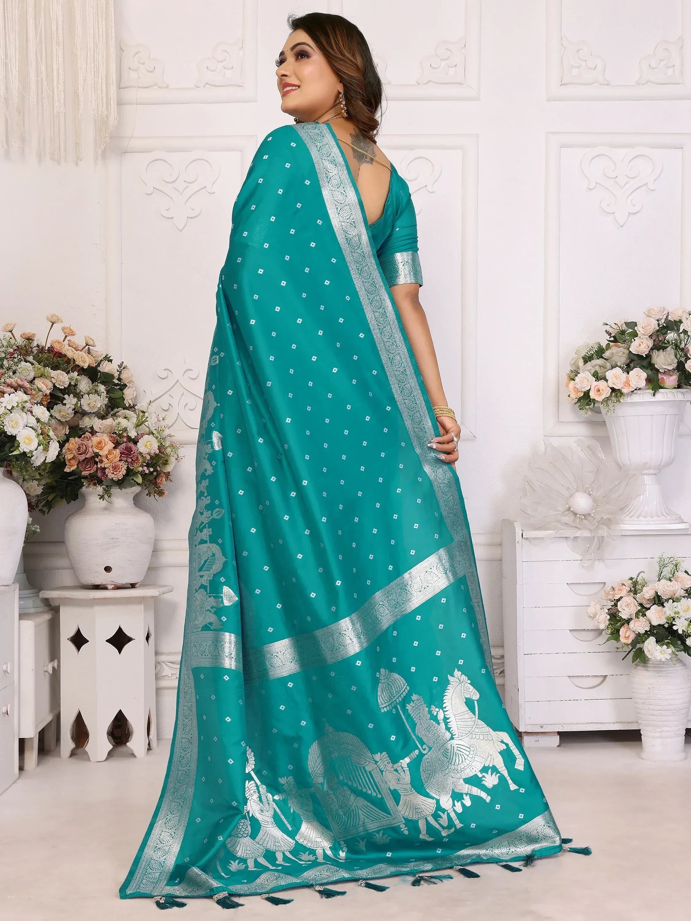 Teal saree with silver horse motifs and intricate border, perfect for ethnic occasions