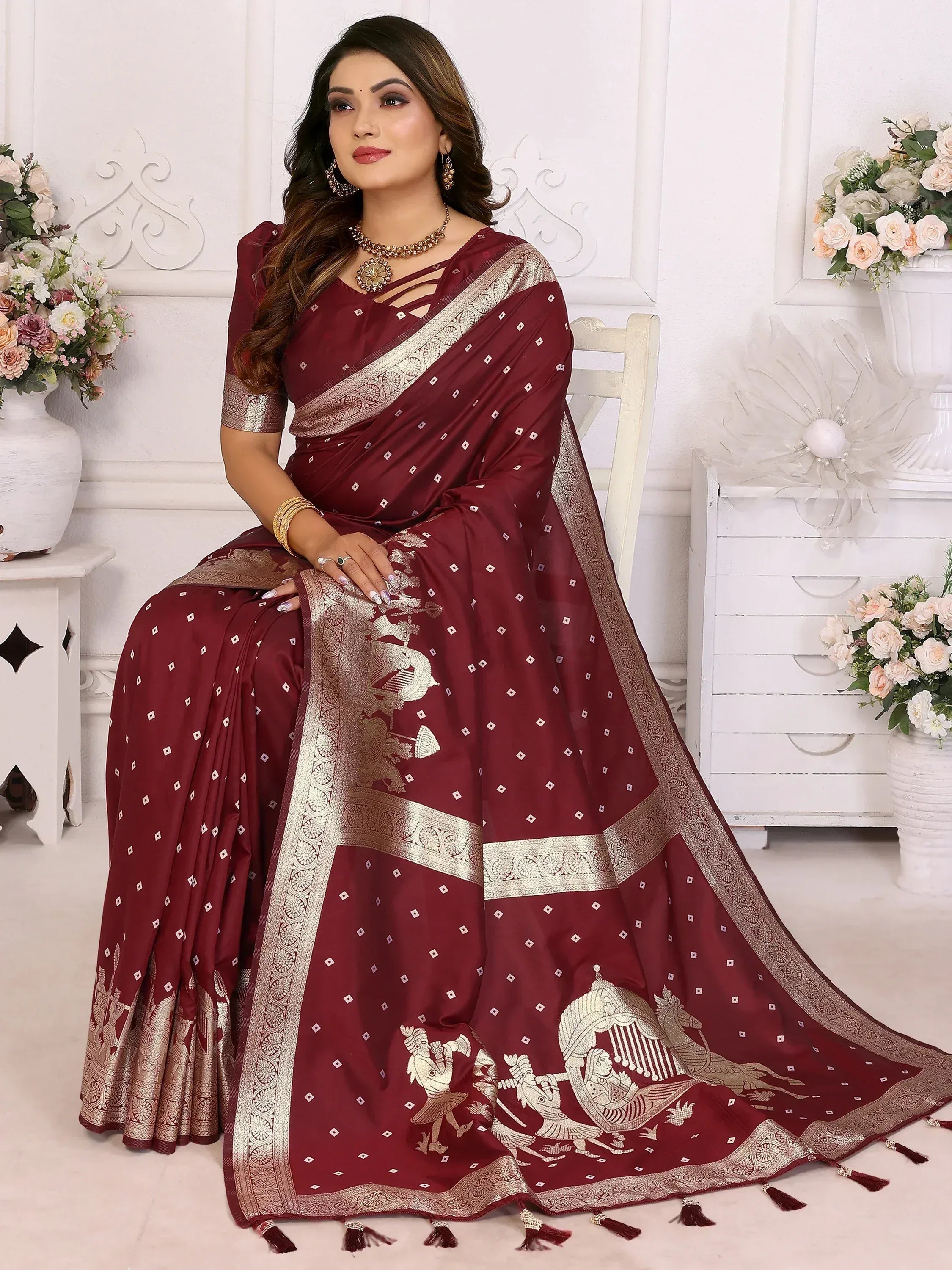 Maroon saree with gold embroidery and tassels, perfect for Indian ethnic wear occasions