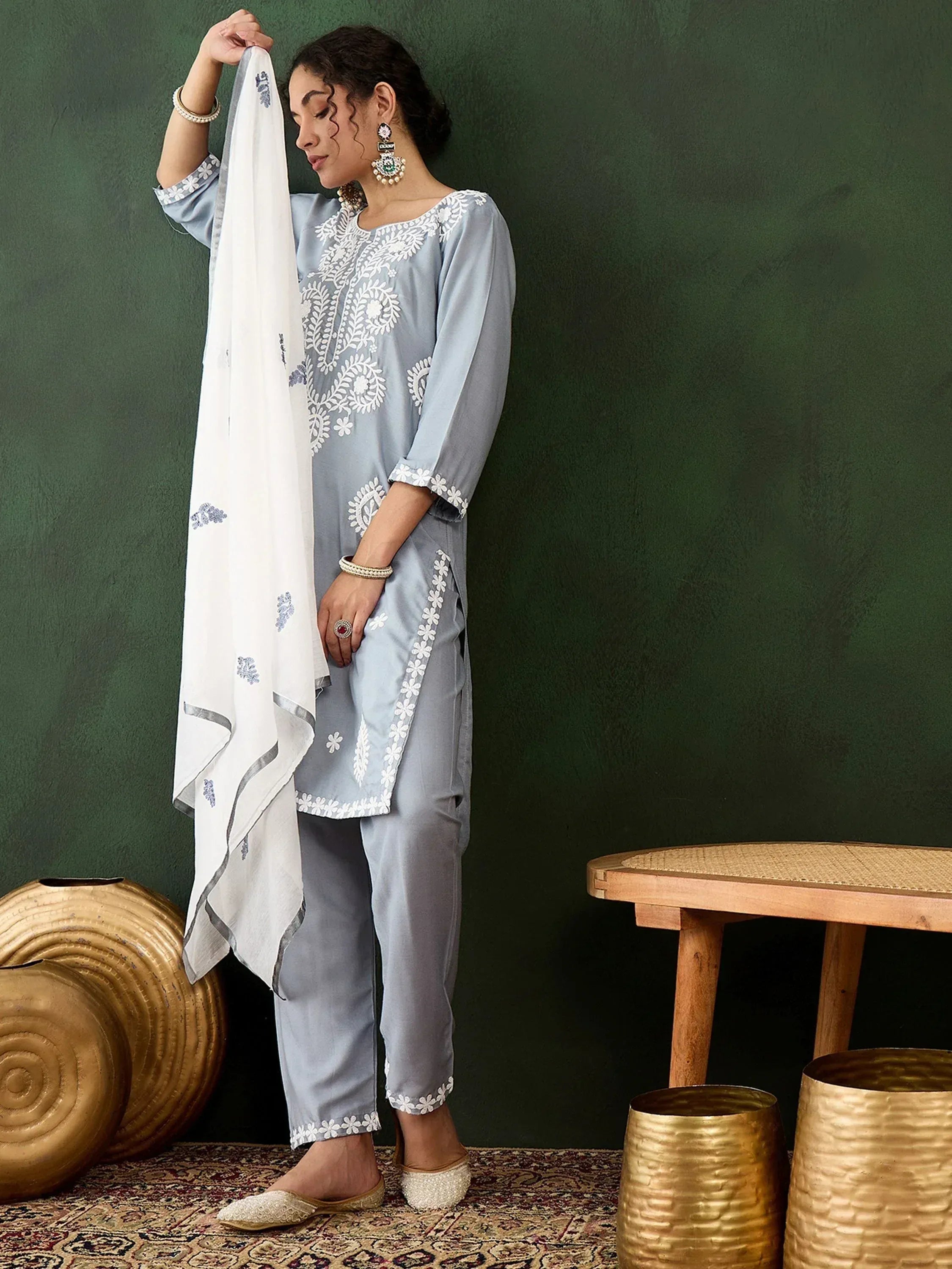 Light blue embroidered salwar kameez with white floral work, paired with matching dupatta and ethnic jewelry