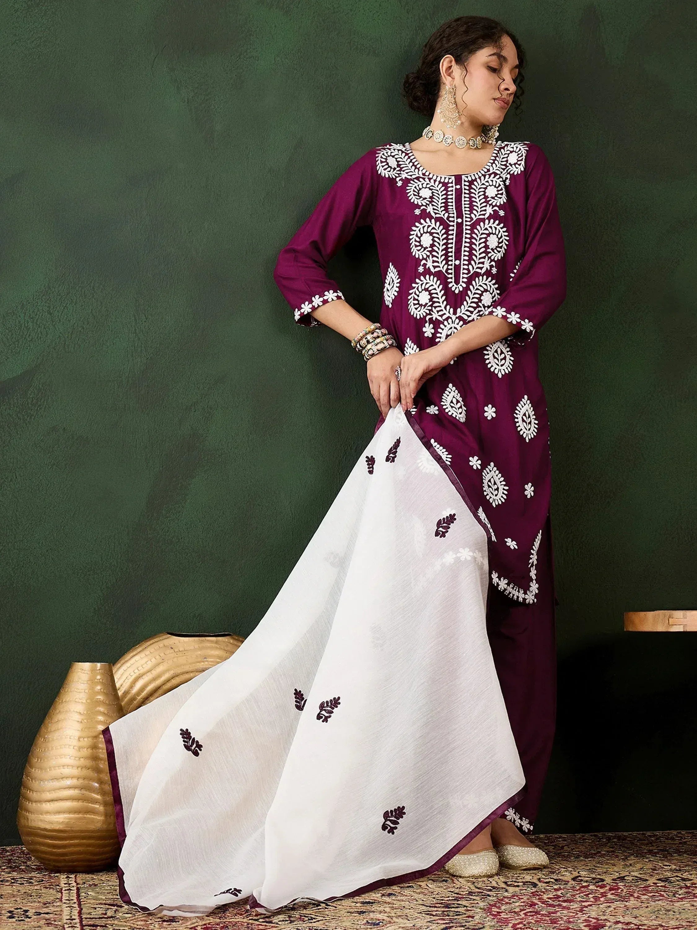 Purple and white embroidered salwar kameez with floral patterns, perfect for ethnic wear occasions.