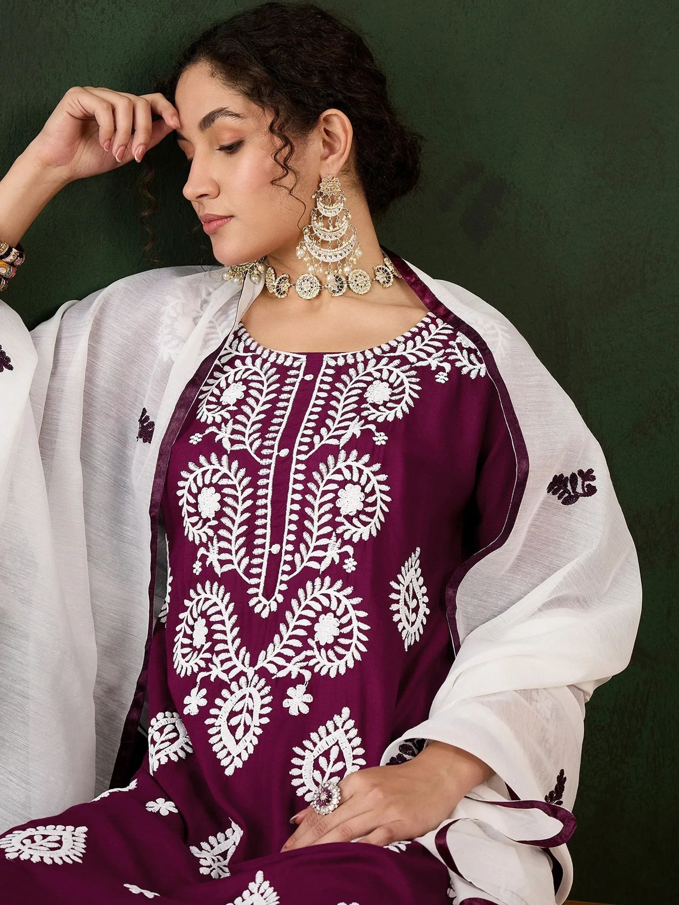 Purple ethnic kurti with white floral embroidery, paired with white dupatta and traditional jewelry