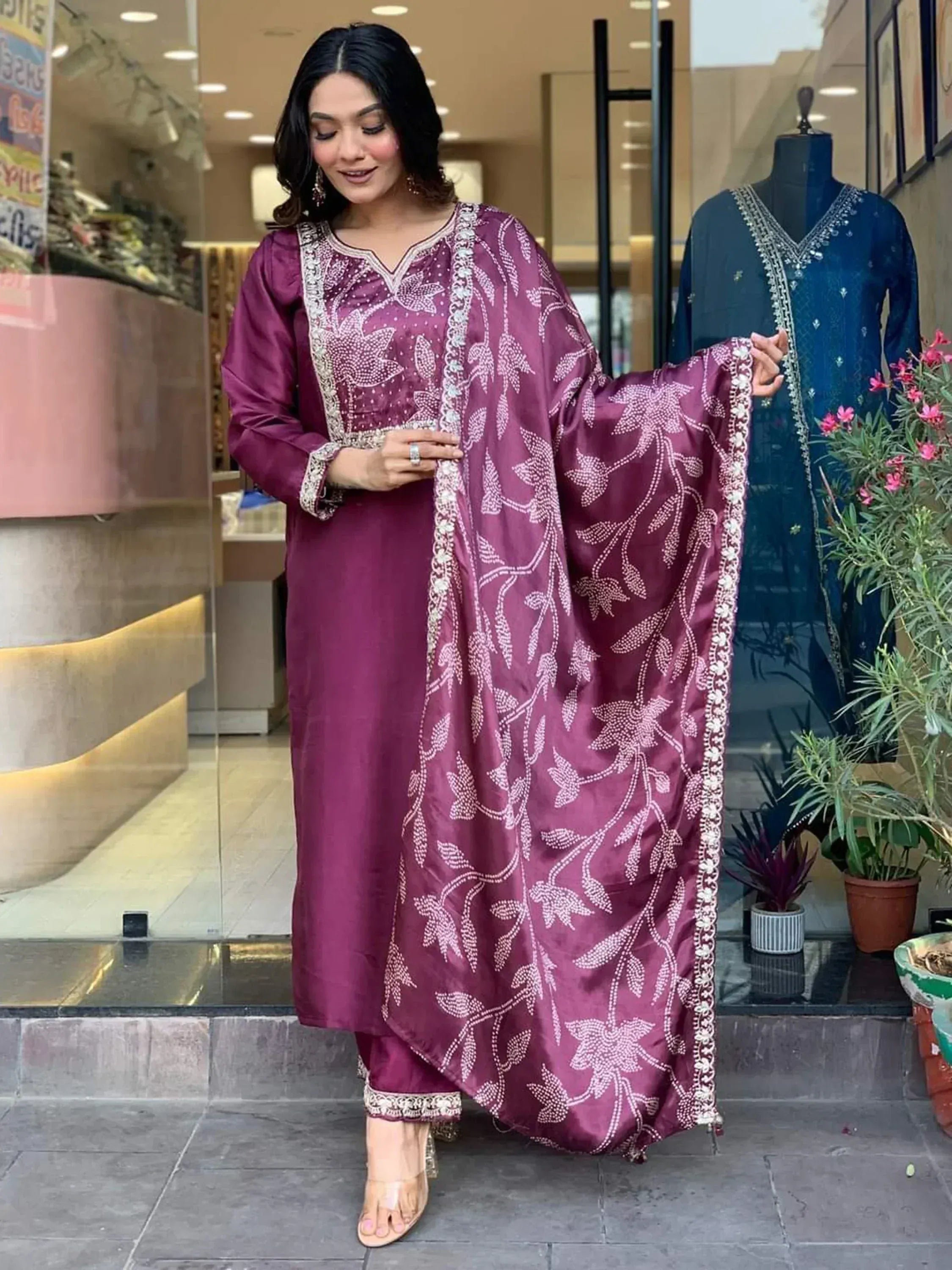 Woman in maroon ethnic salwar kameez with floral embroidery, perfect for Indian occasions