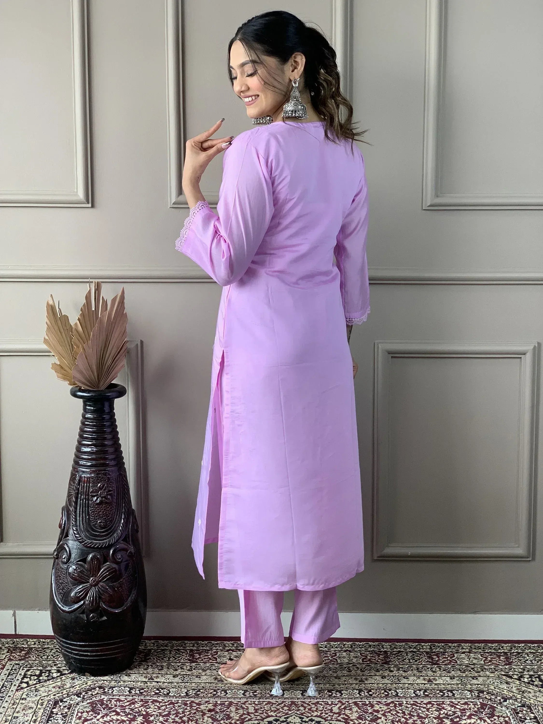 Lavender ethnic kurta with lace sleeves and matching pants, styled with jhumka earrings for festive occasions.
