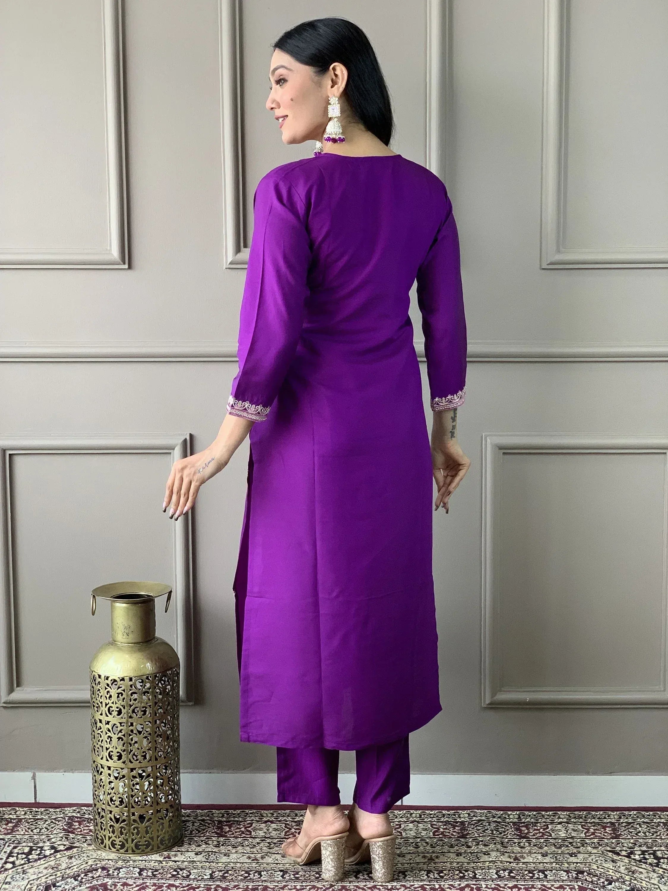 Purple ethnic kurta with embroidered cuffs, paired with matching pants and heels, styled for Indian wear.