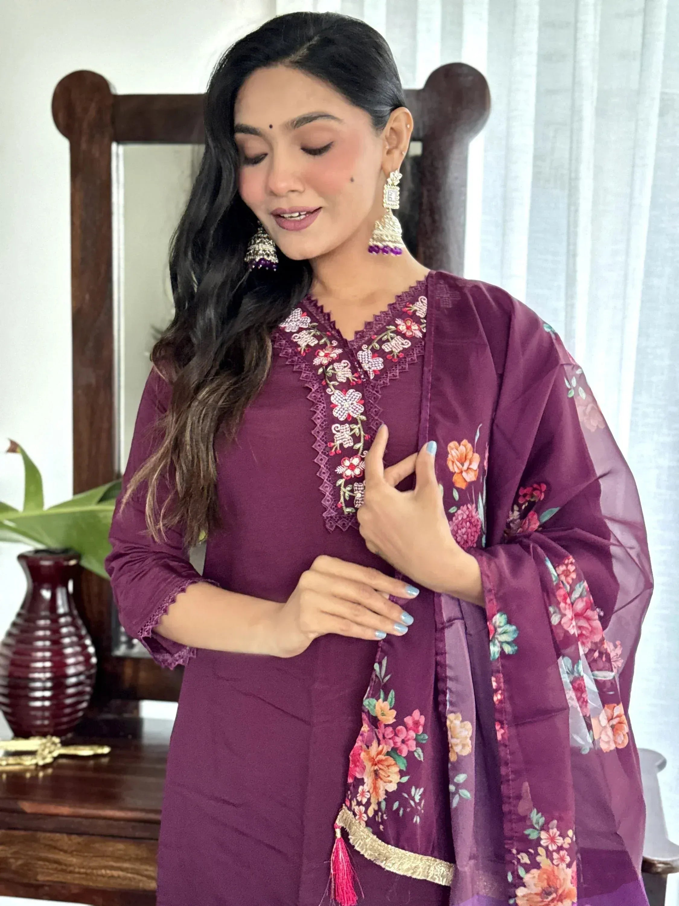 Woman in purple embroidered salwar kameez with floral dupatta, ethnic Indian wear