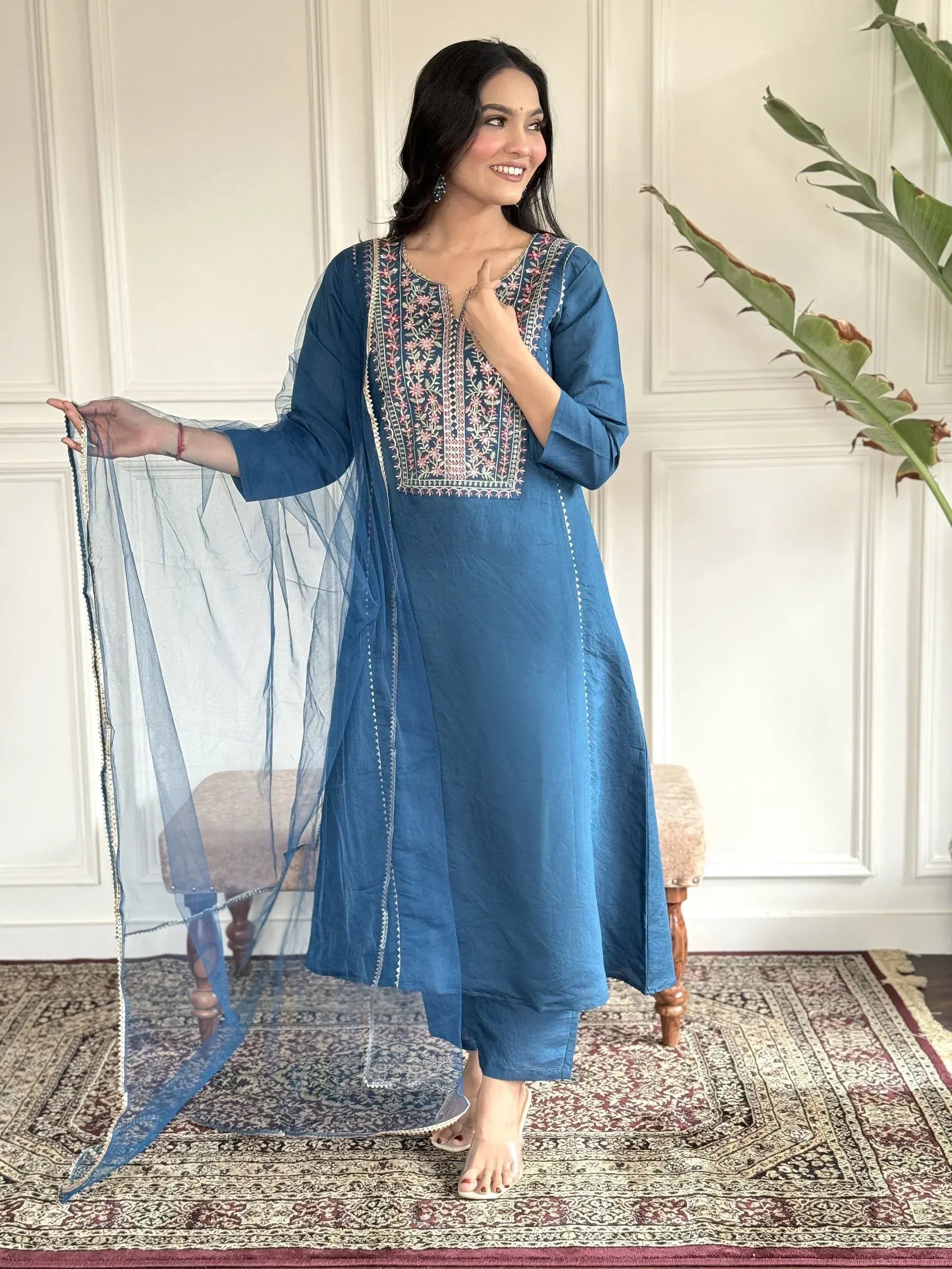 Blue embroidered salwar kameez with floral neckline, sheer dupatta, and matching pants for ethnic wear