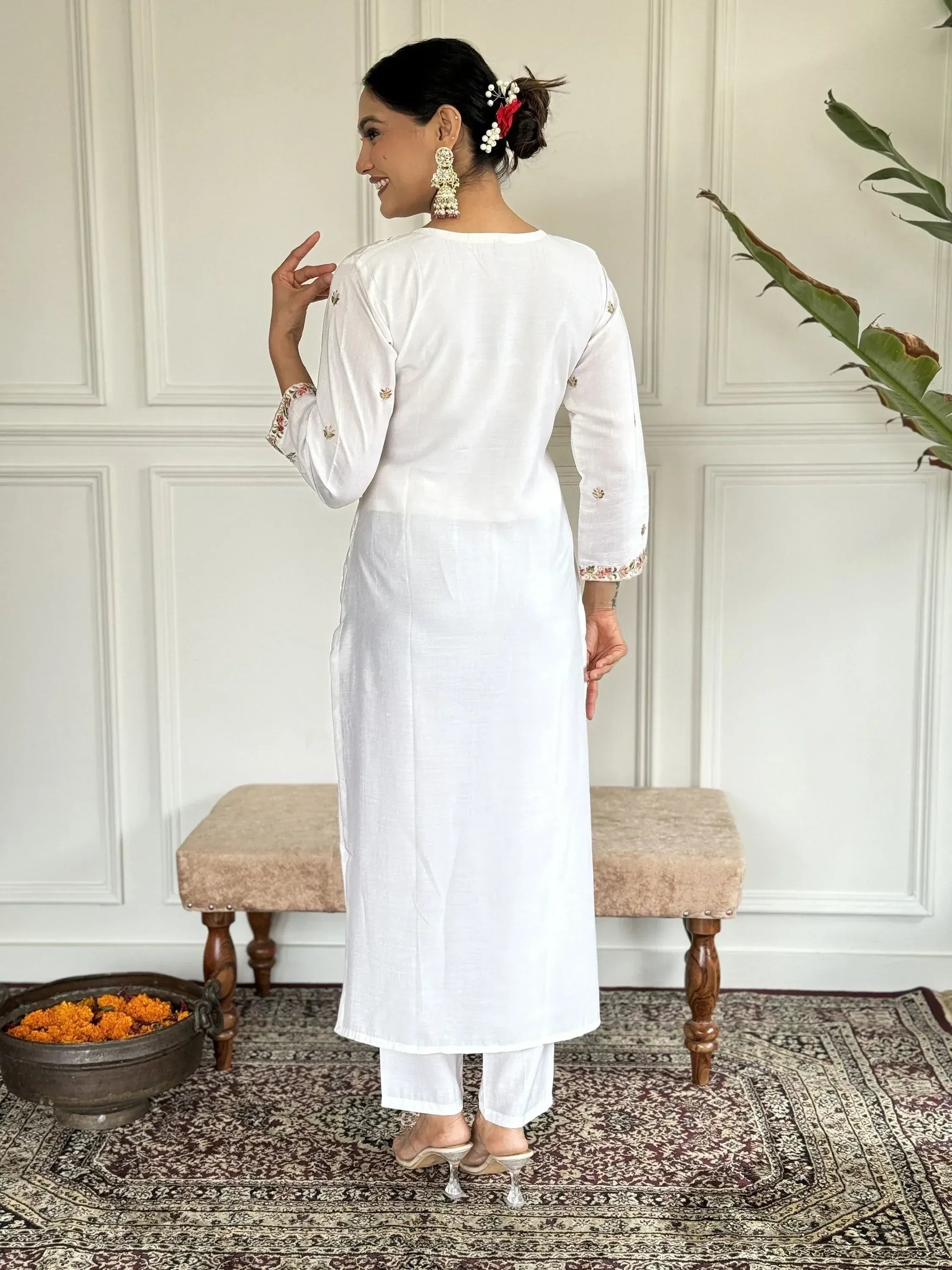 White embroidered kurta with floral sleeve details, paired with palazzo pants, ideal for Indian ethnic wear.