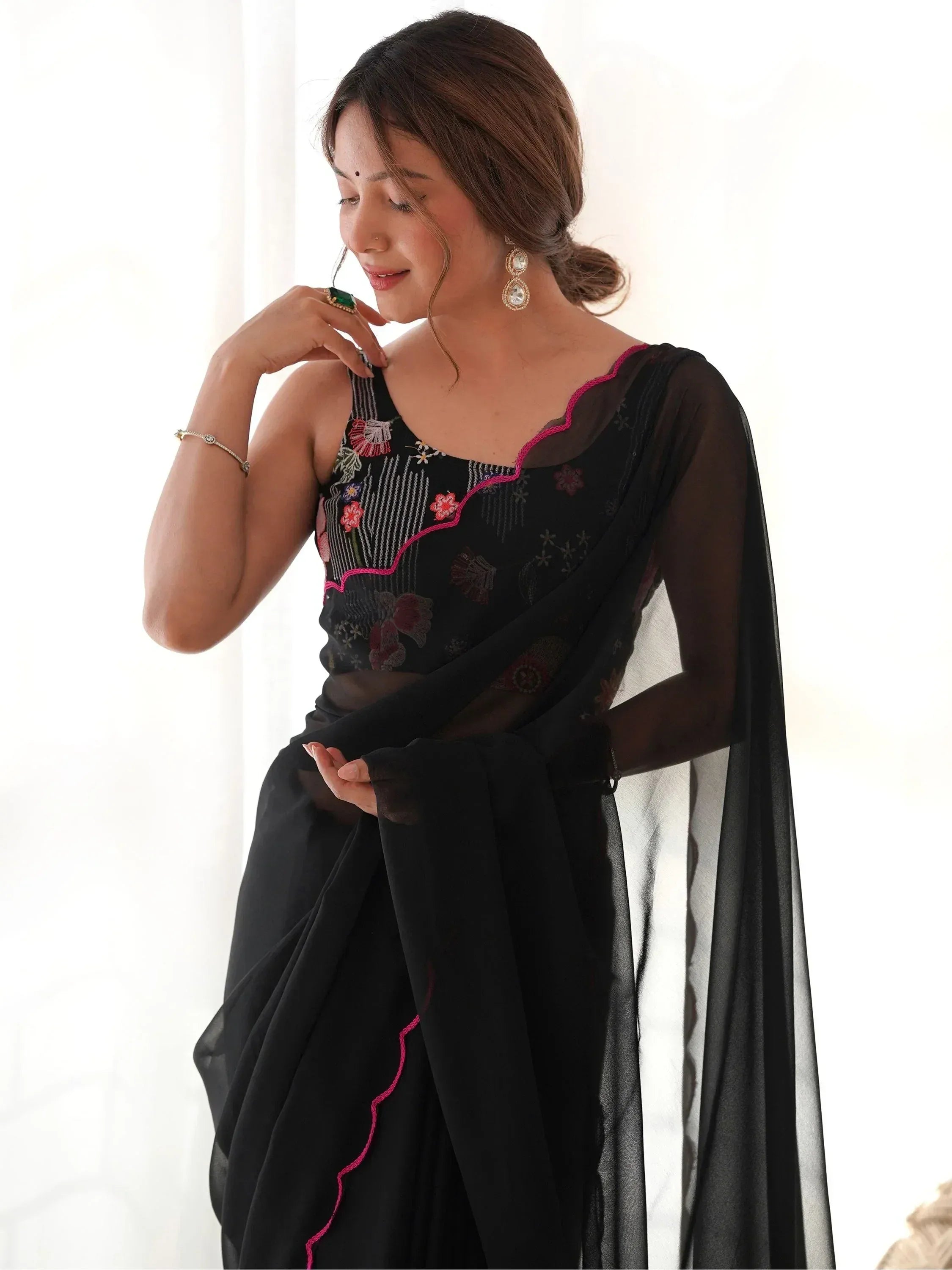 Black embroidered saree with pink detailing, perfect for Indian ethnic wear occasions