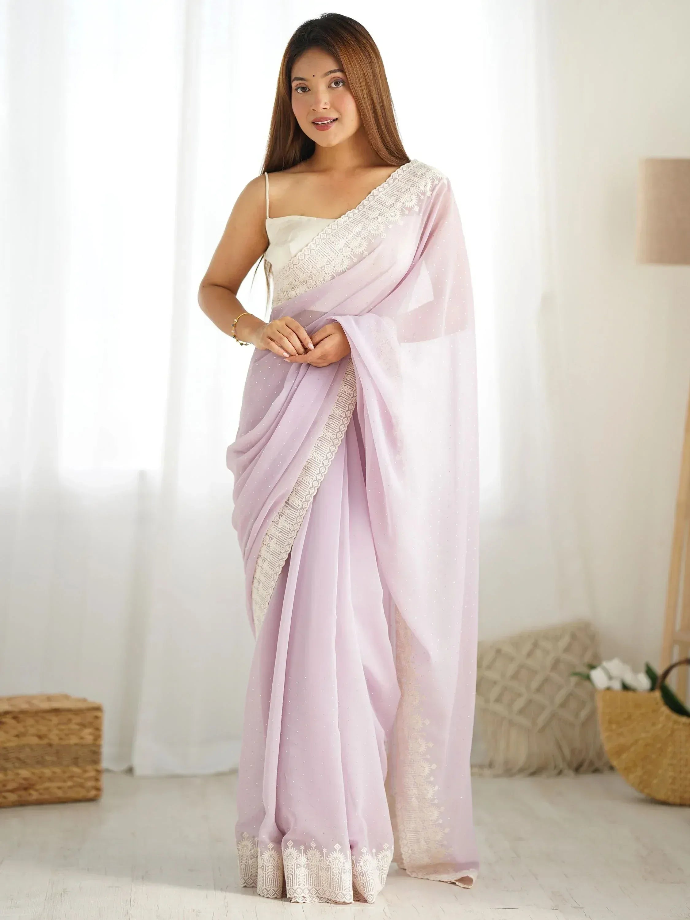 Lavender saree with white embroidery and sequins, paired with a white blouse, ideal for Indian ethnic wear.
