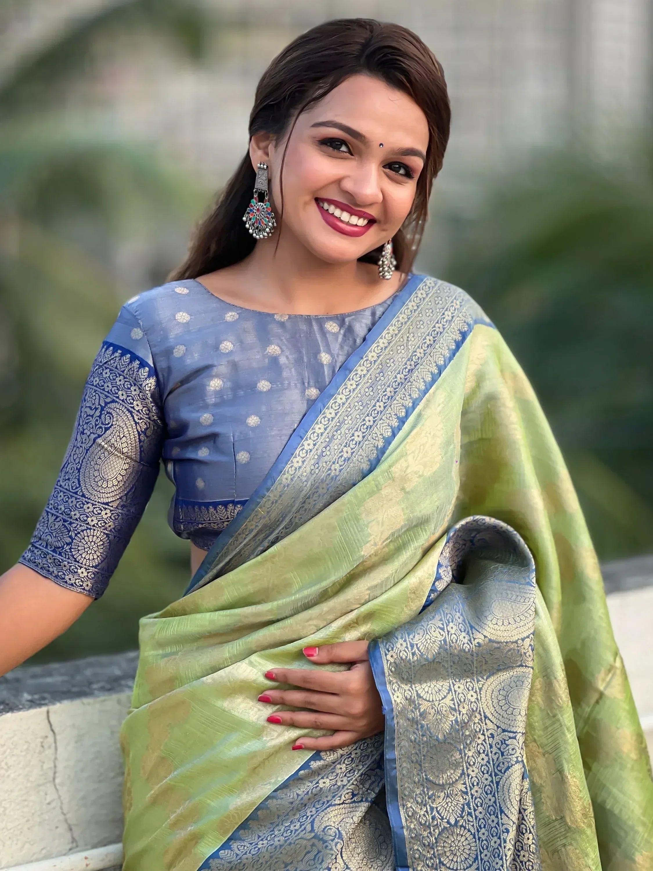 Woman in blue and green designer saree with gold embroidery, ethnic wear for festive occasions