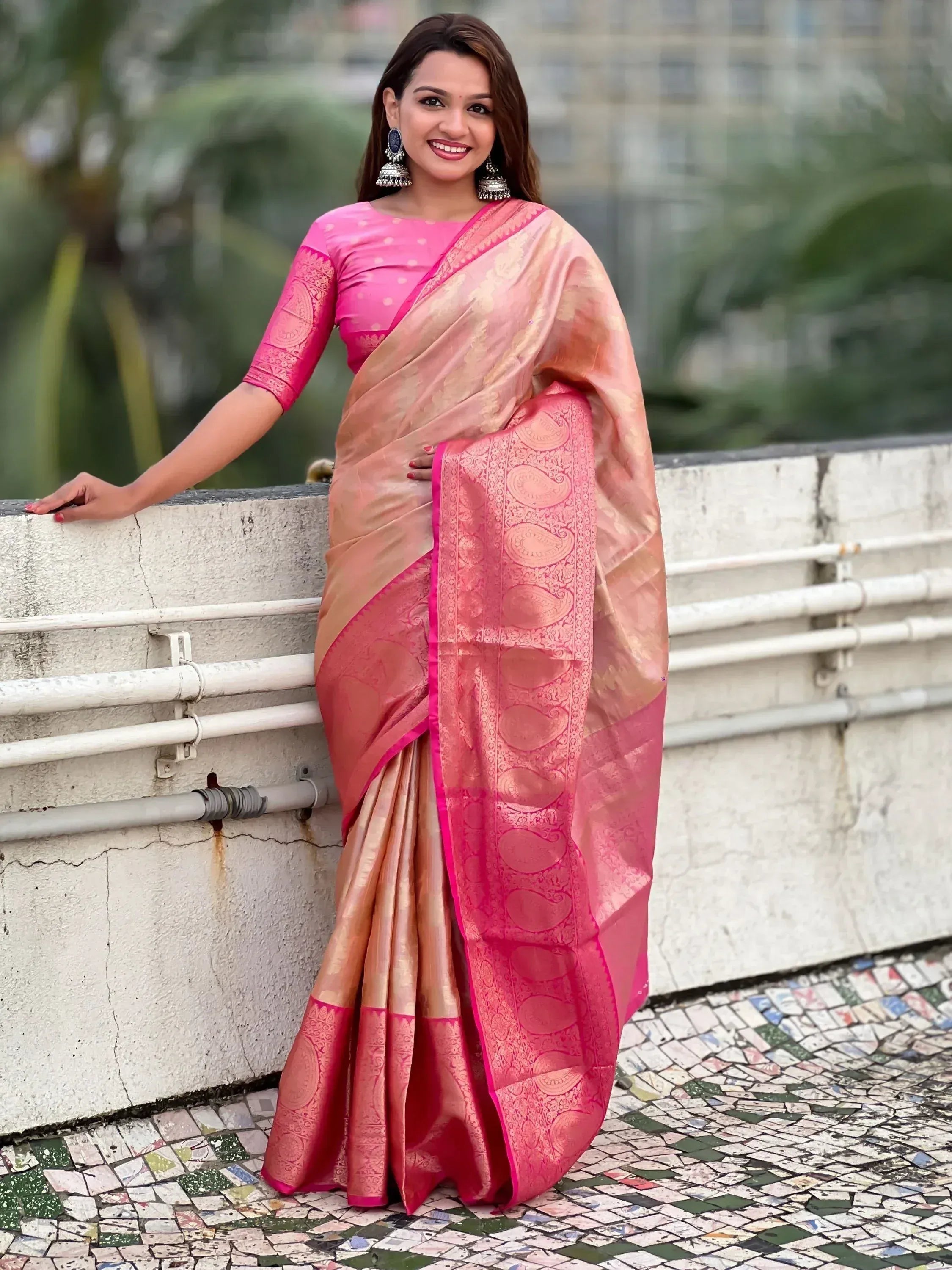 Pink and gold designer saree with paisley border, paired with matching blouse, perfect for ethnic occasions