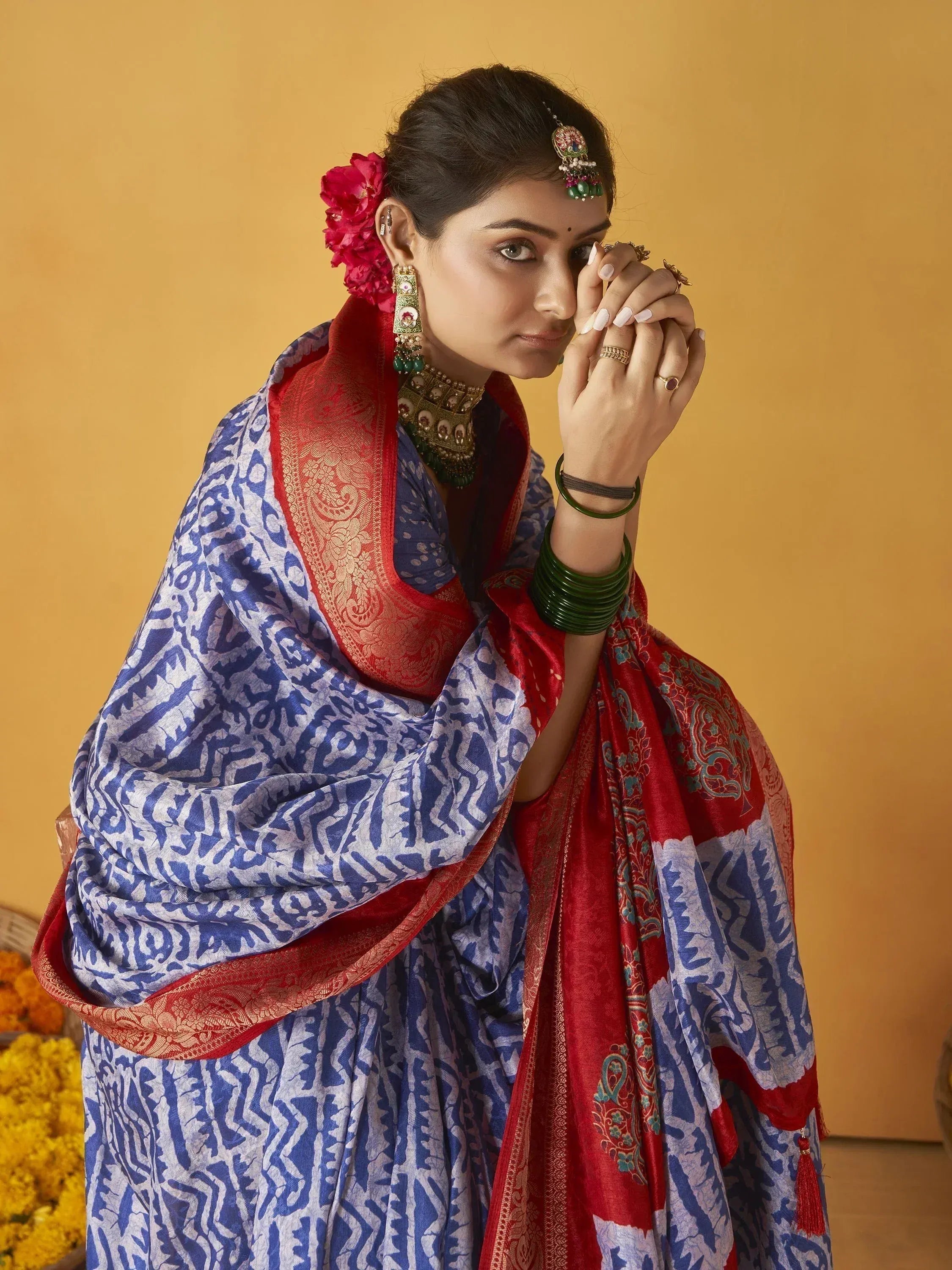 Blue and red printed saree with gold border, traditional Indian ethnic wear, styled with temple jewelry and green bangles