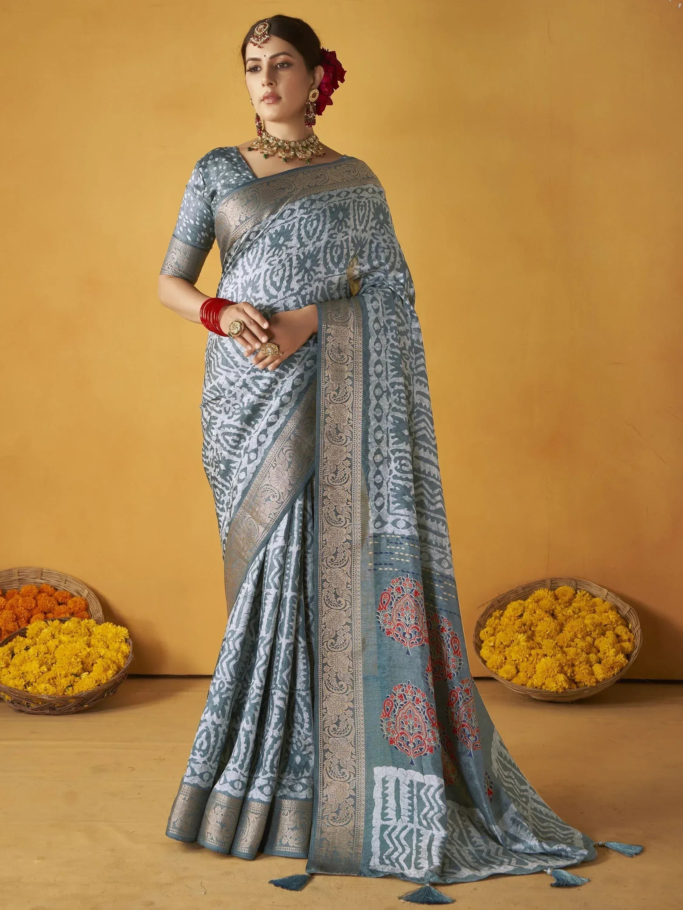 Blue printed saree with gold border, traditional Indian ethnic wear for women, styled with jewelry and marigolds