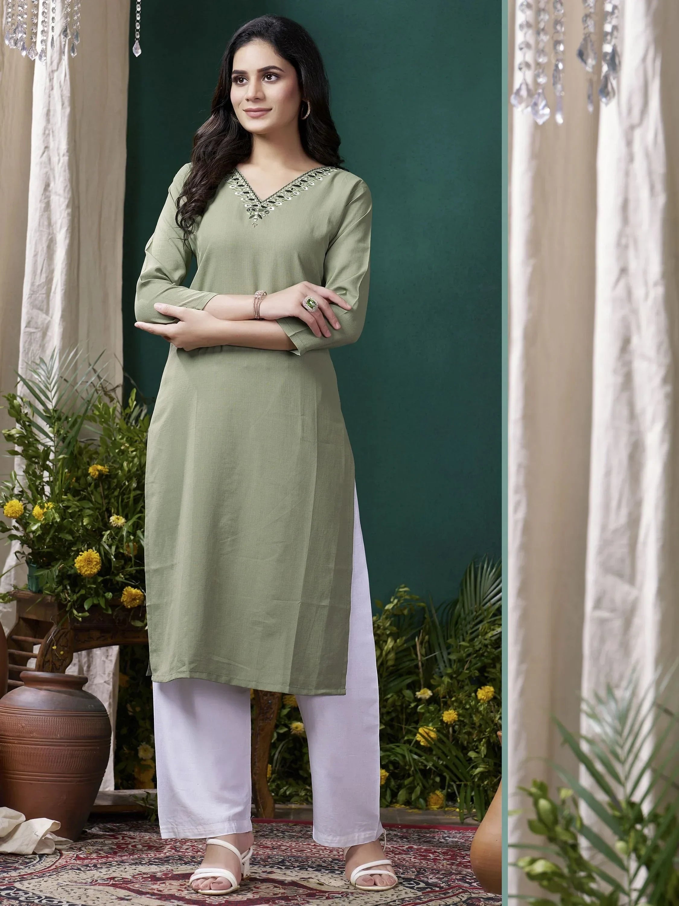 Woman in sage green kurta with embroidery, white palazzo pants, ethnic wear setting