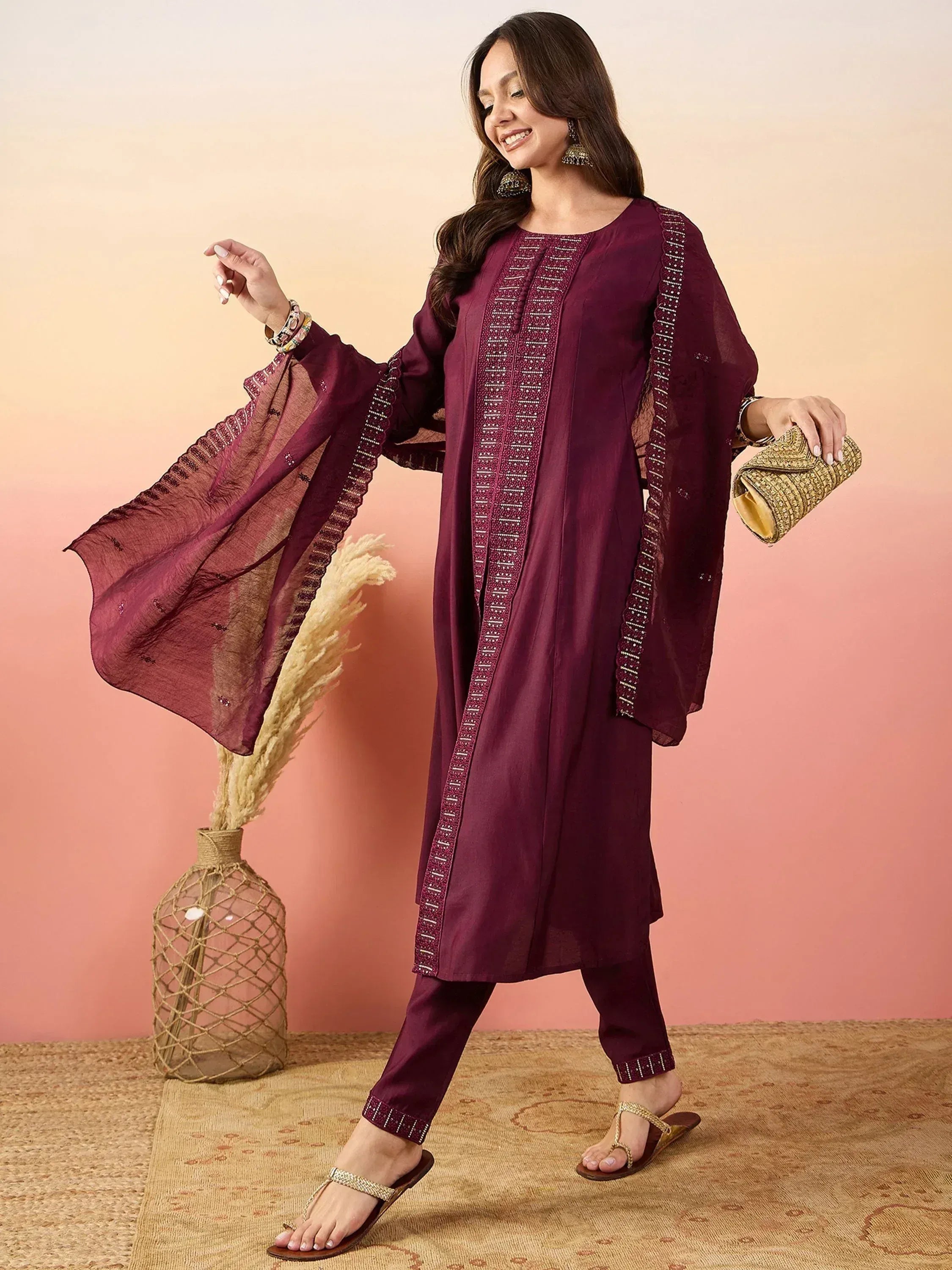 Elegant maroon salwar kameez with embroidery, paired with a matching dupatta and gold accessories.