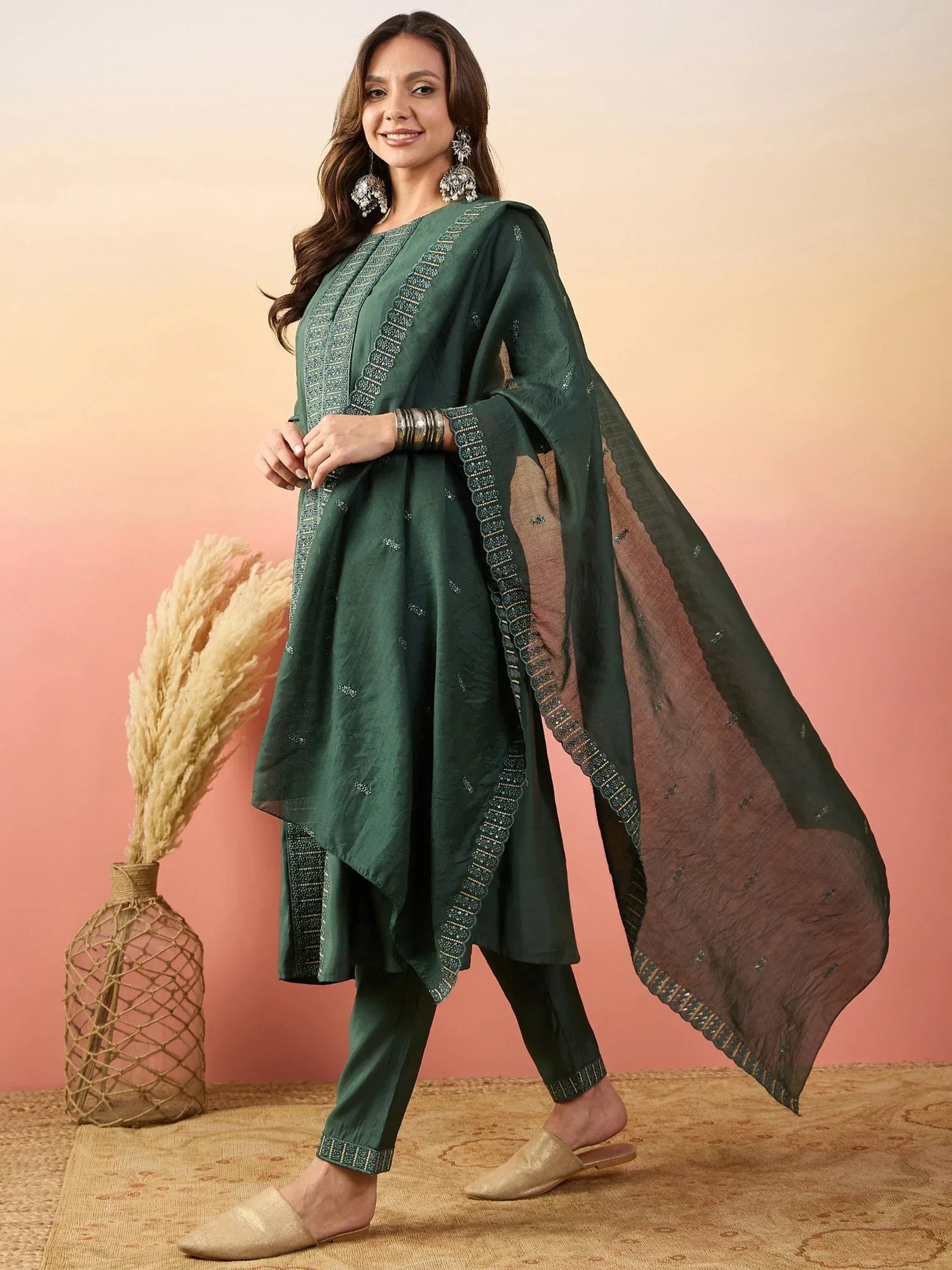 Elegant green ethnic salwar kameez with intricate embroidery and matching dupatta, perfect for festive occasions.