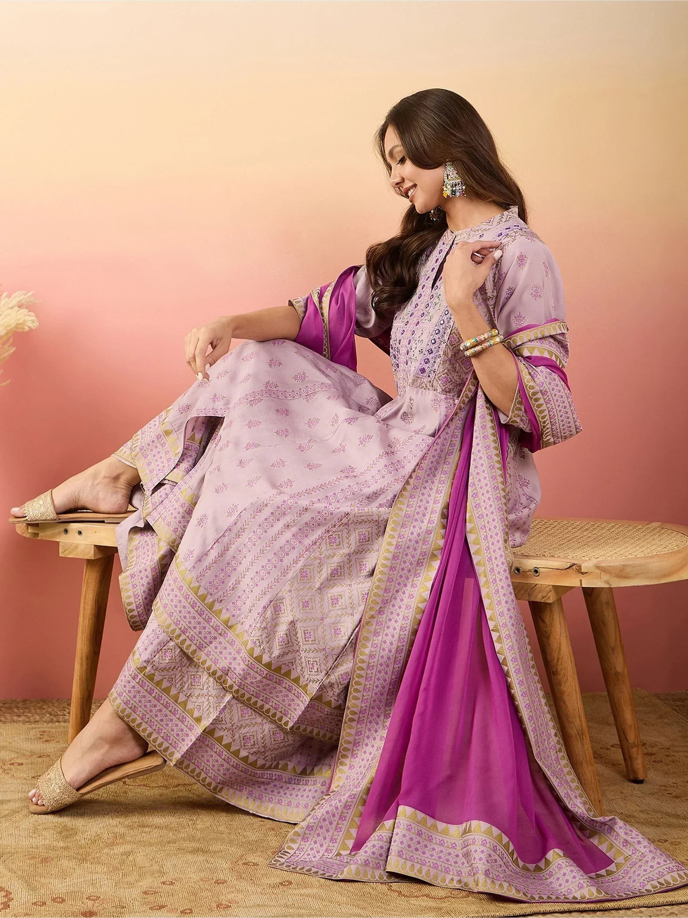 Woman in lavender printed ethnic gown with magenta dupatta, traditional Indian wear