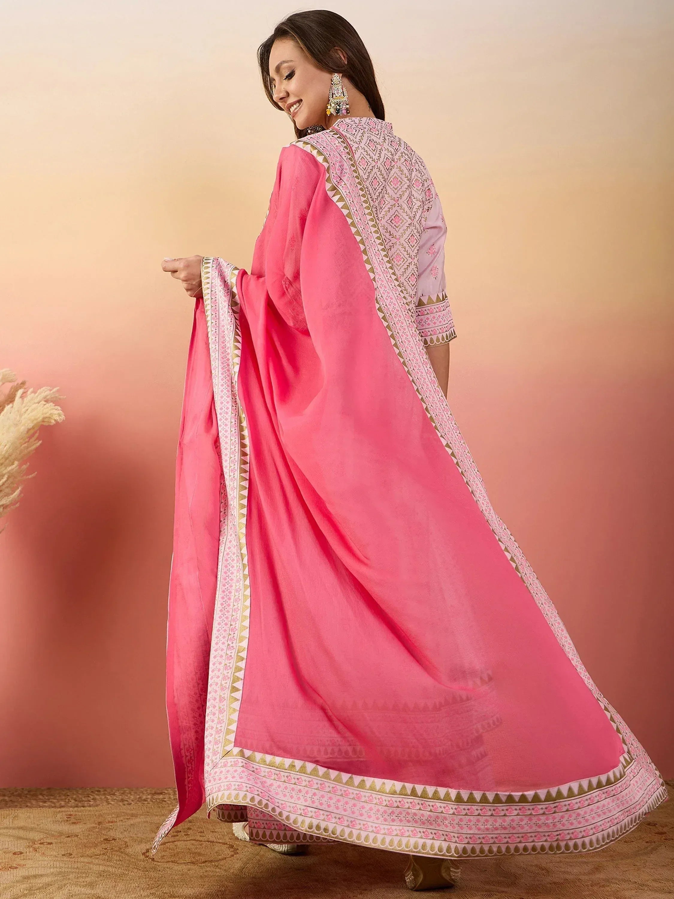 Pink printed salwar kameez with ethnic embroidery and dupatta, ideal for Indian festive occasions