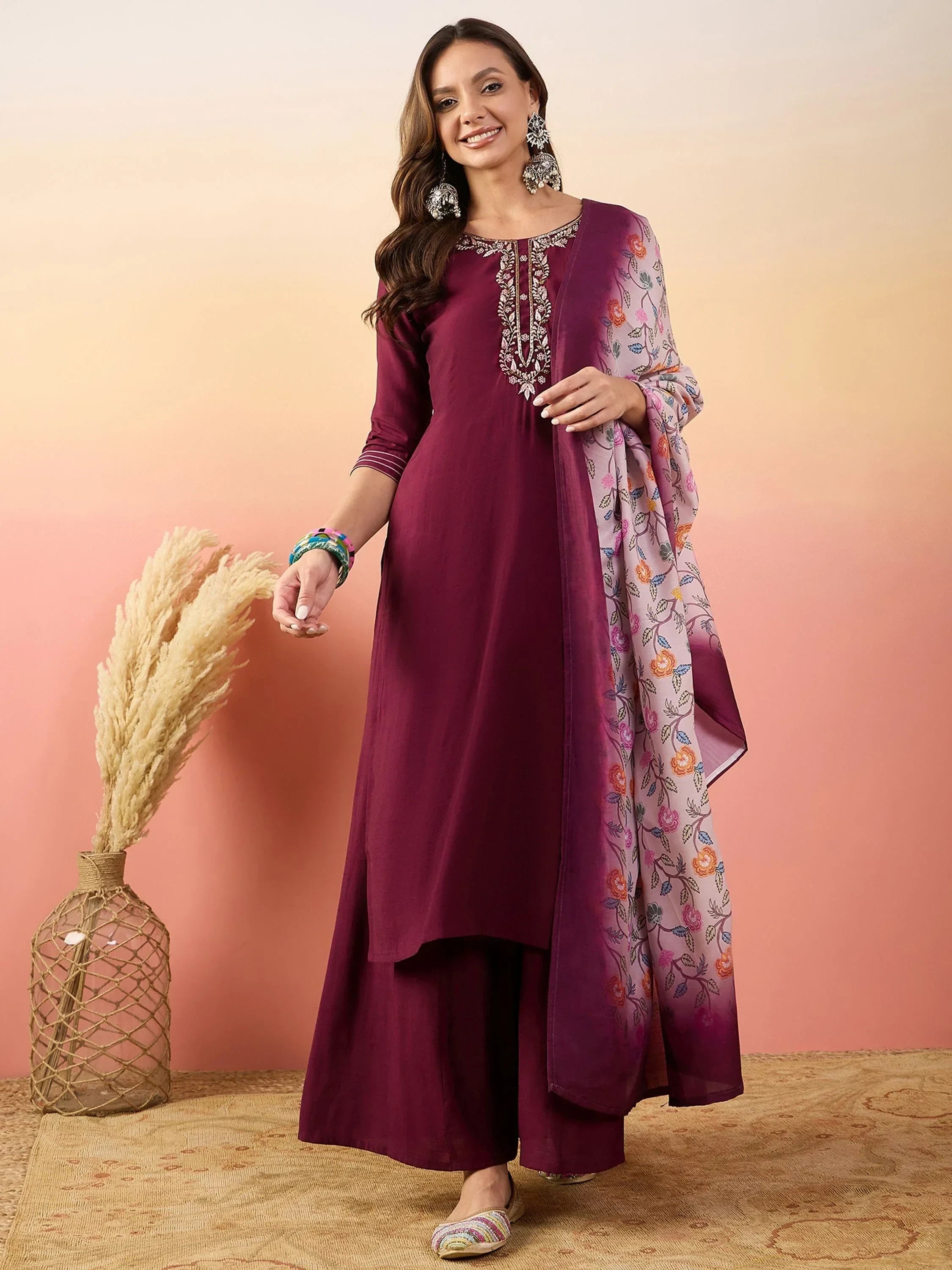 Woman in maroon ethnic kurta palazzo set with embroidered neckline and floral dupatta
