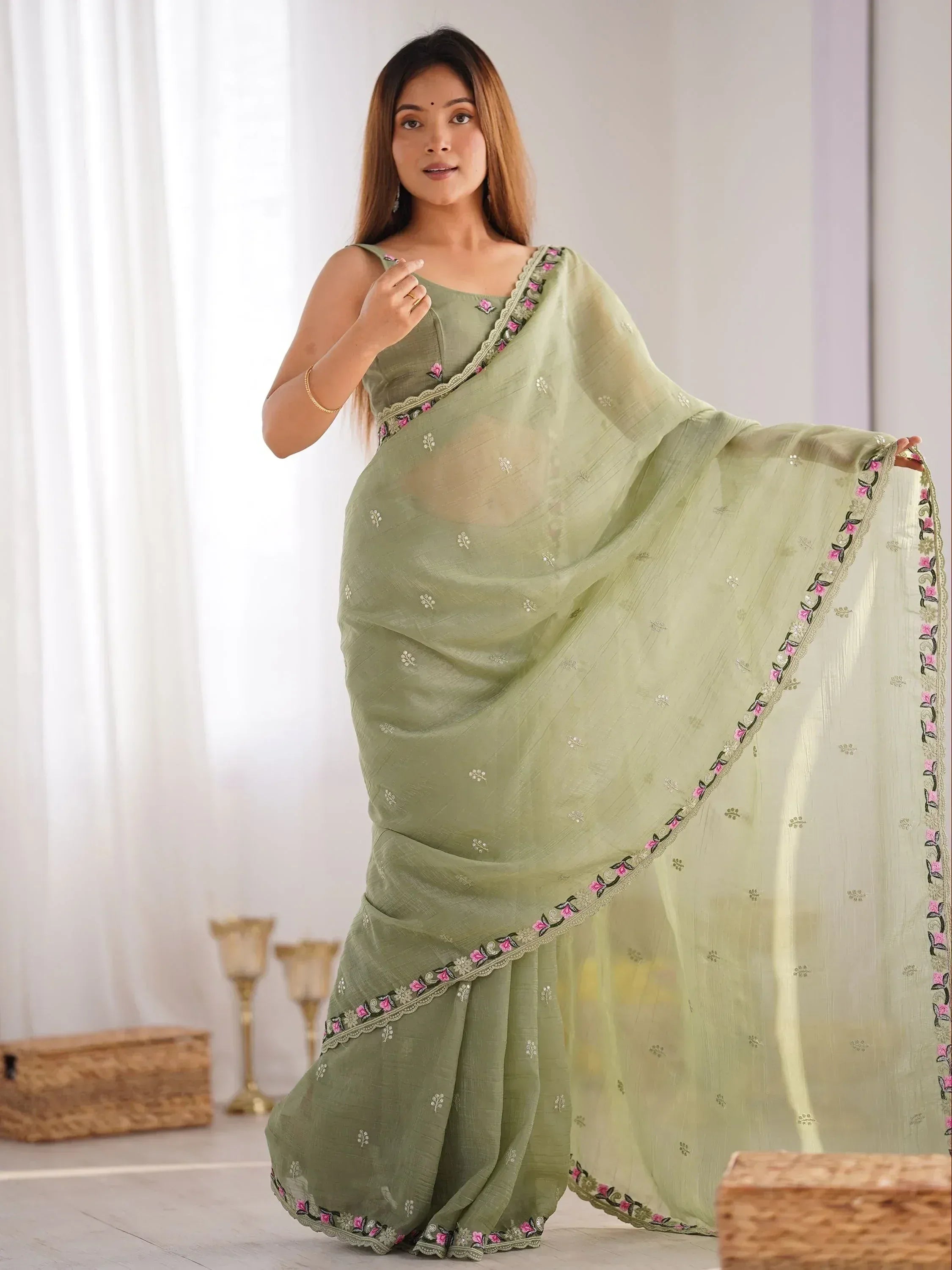 Light green embroidered saree with floral border, stylish Indian ethnic wear for women