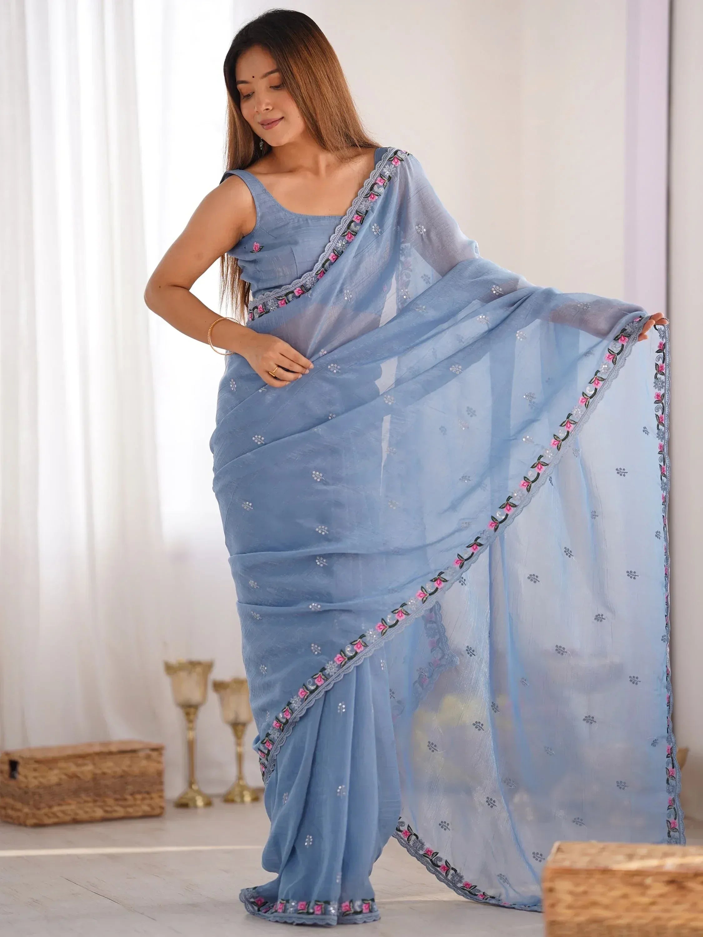 Light blue embroidered saree with floral border, stylish Indian ethnic wear for women