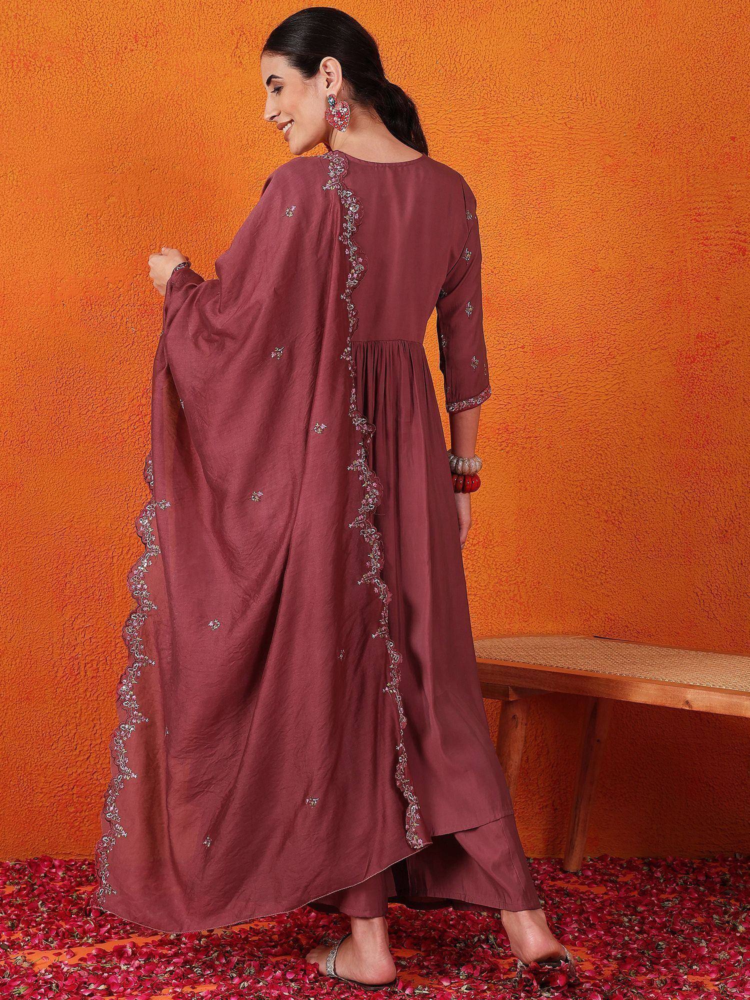 Maroon ethnic gown with silver embroidery, worn with palazzo pants, against orange wall with rose petals