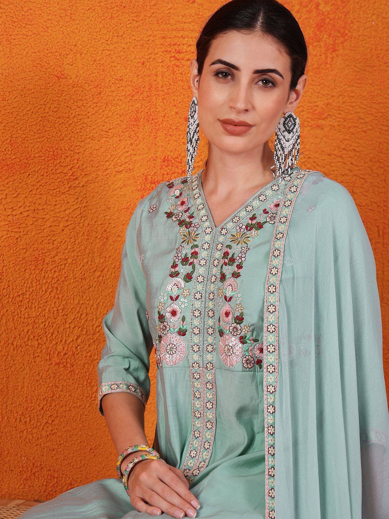 Mint green embroidered kurta with floral detailing, paired with matching dupatta and statement earrings