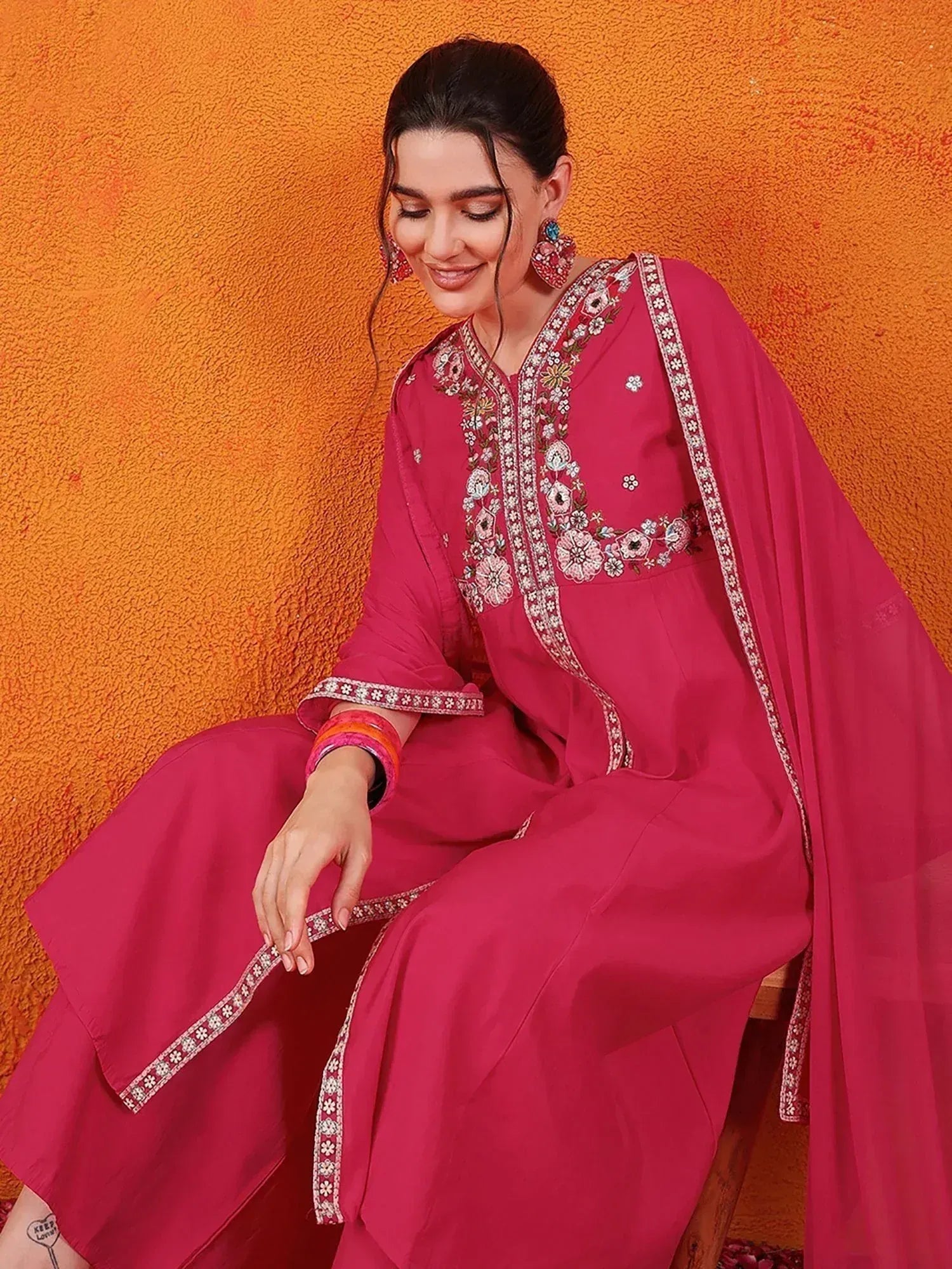 Pink embroidered salwar kameez with floral detailing, perfect for ethnic wear occasions