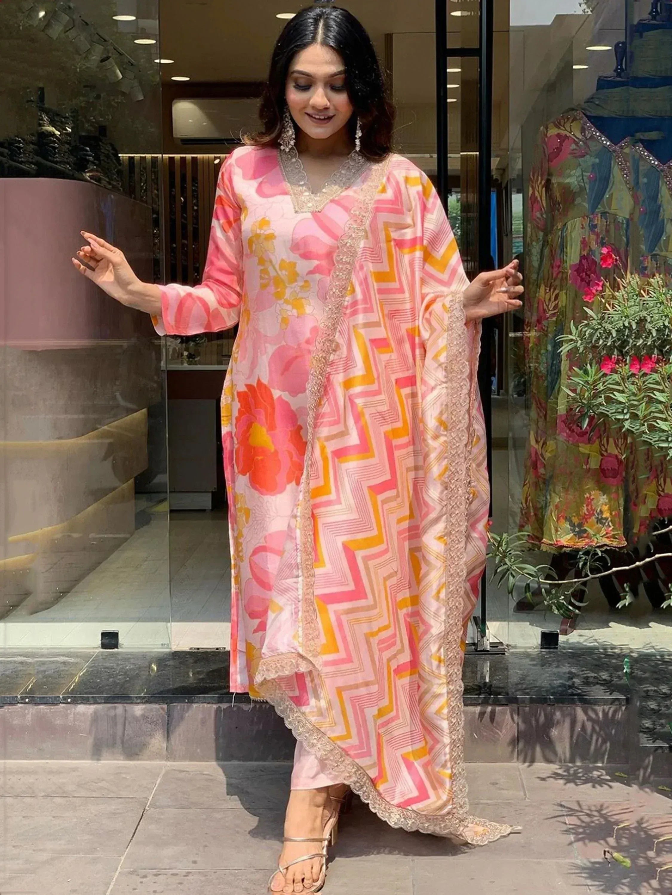 Pink floral and geometric print ethnic gown with lace detailing, perfect for Indian festive occasions