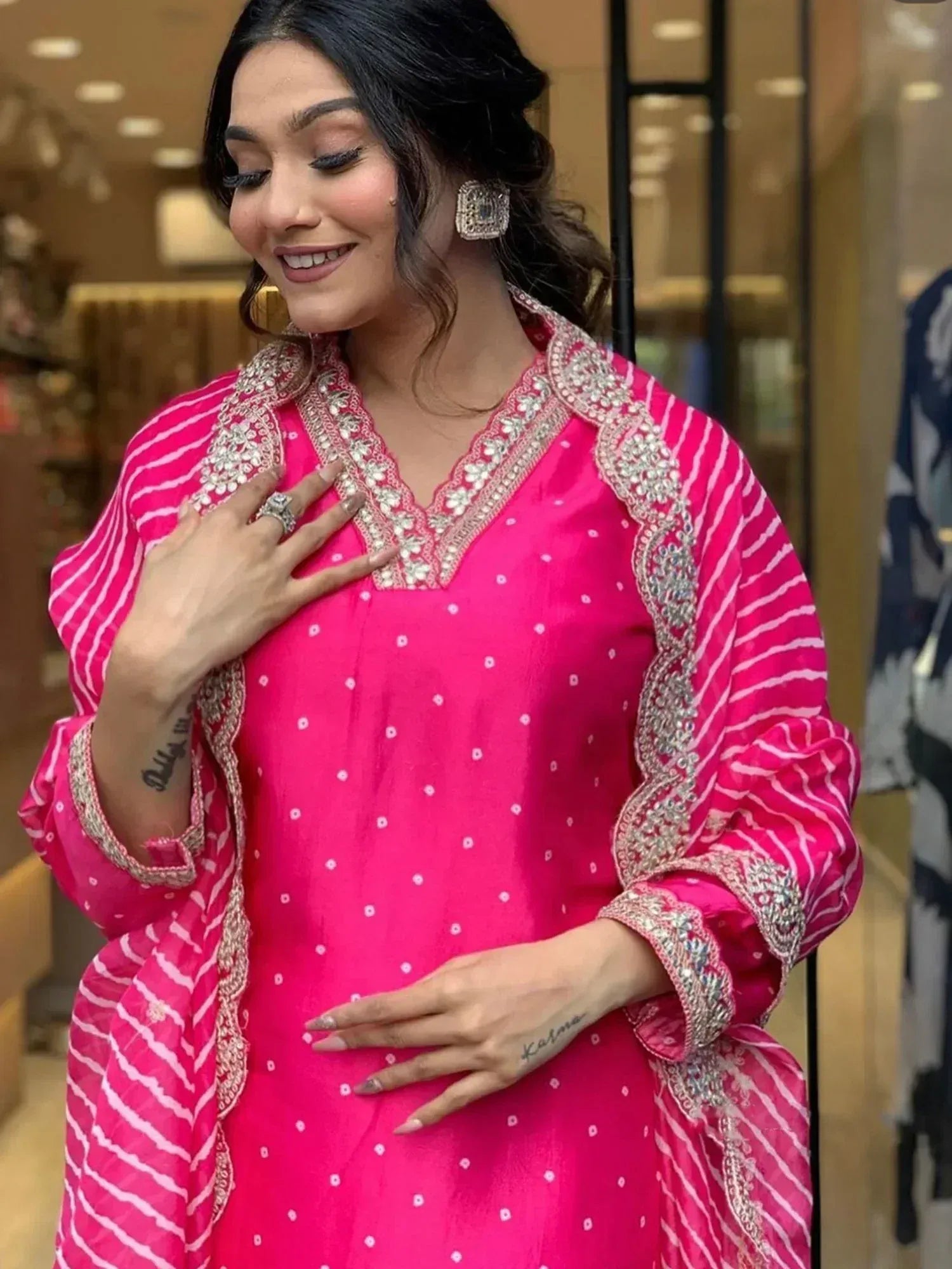 Pink embroidered ethnic kurti with white stripes and detailed neckline design